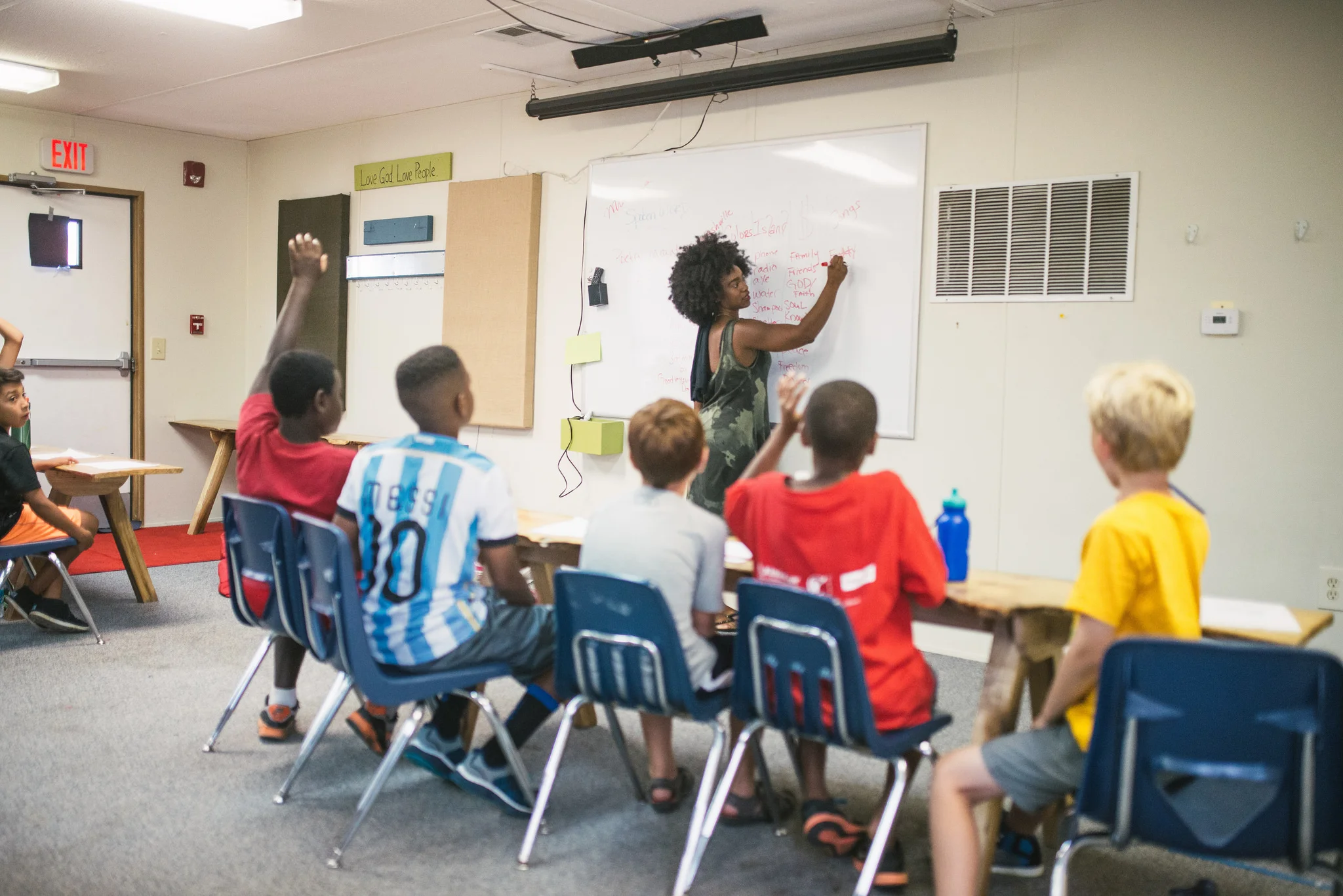 Students listen and learn about poetry at our Camp Skillz program. Poetry teaches kids to use language in dynamic and creative ways. Listening to poetry, students can hear words spoken with images and rhythms that draw them into considering a truth or issue they might not otherwise contemplate. 