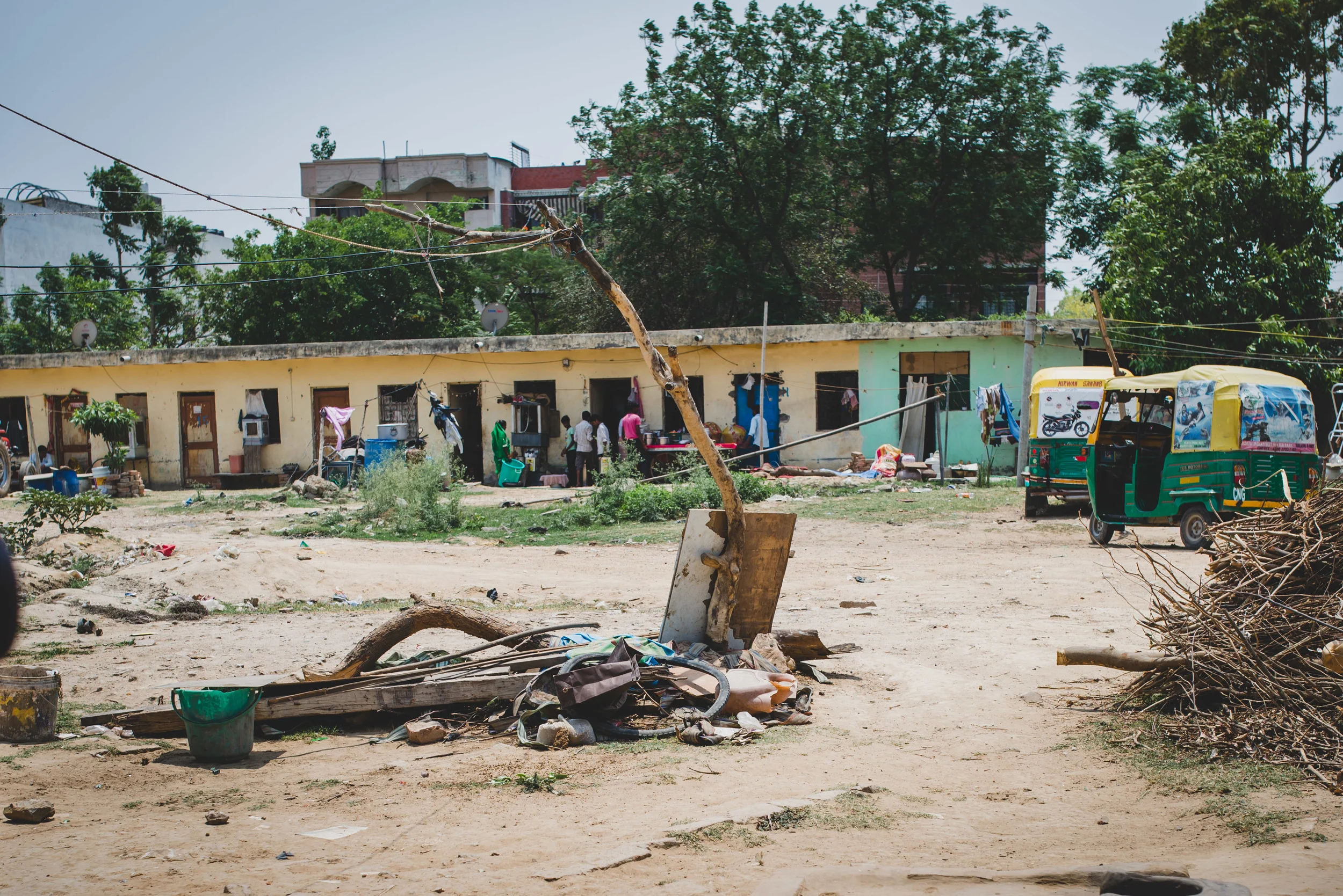 On one side of the courtyard, a single pipe provides water for the 30 families that live in this community of migrant workers.