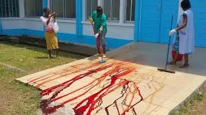 The blood-drenched clinic porch being cleaned off after pregnant, Cameroon mother dies along with her twin babies, for being refused treatment.