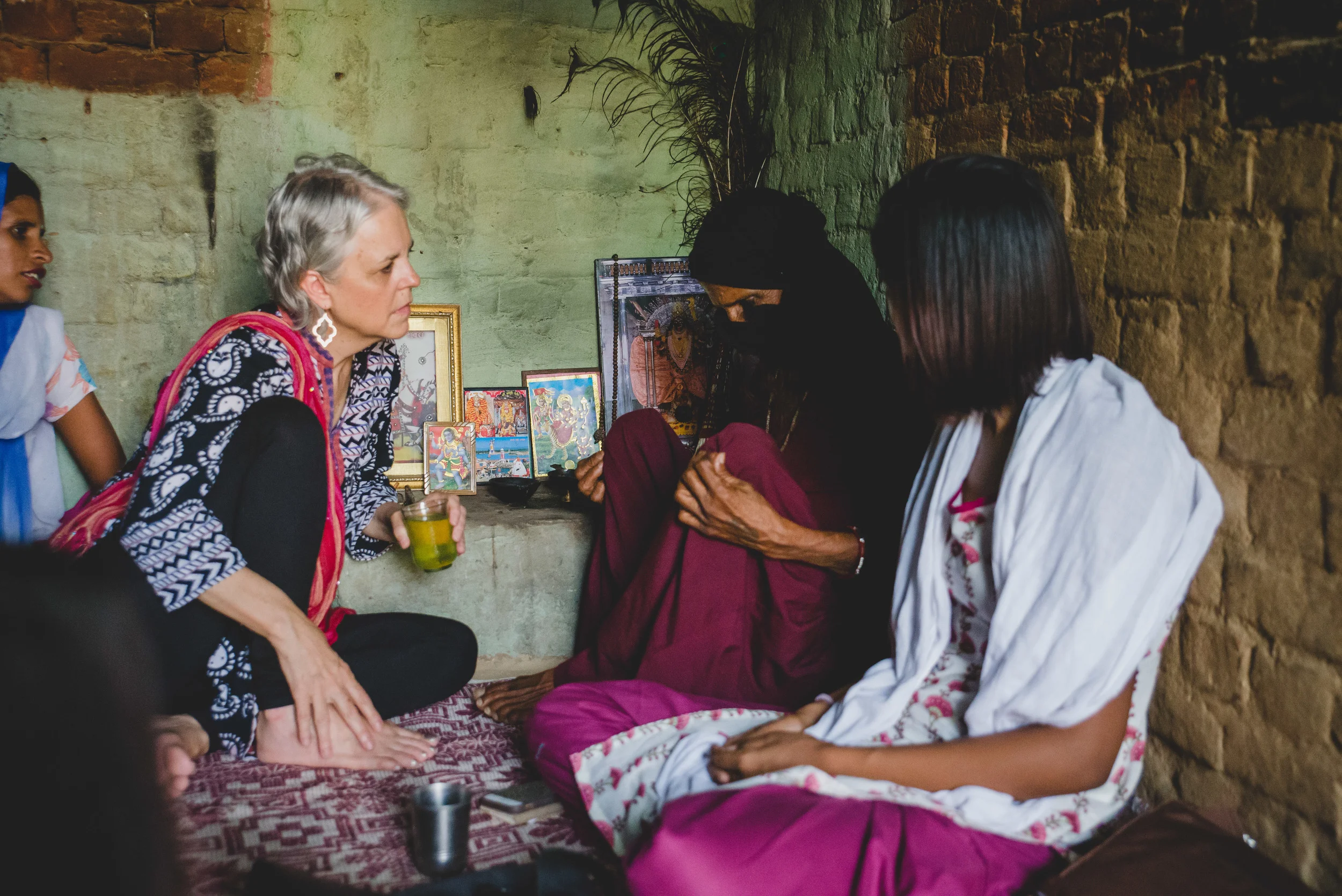 Demonstrating a purity practice, she talks about the stigma associated with village midwives. "When my son was young, someone told him 'your mother works with dirt, so she is dirty.' Some people would not eat from my hand or drink water from me. I told my son to come and look at me through the mesh when I helped a woman deliver her baby. I let him see that I covered my face and did not touch anything dirty. I would not let my body heat get on anything,” she said. "I wanted my son to see that my work is not dirty."