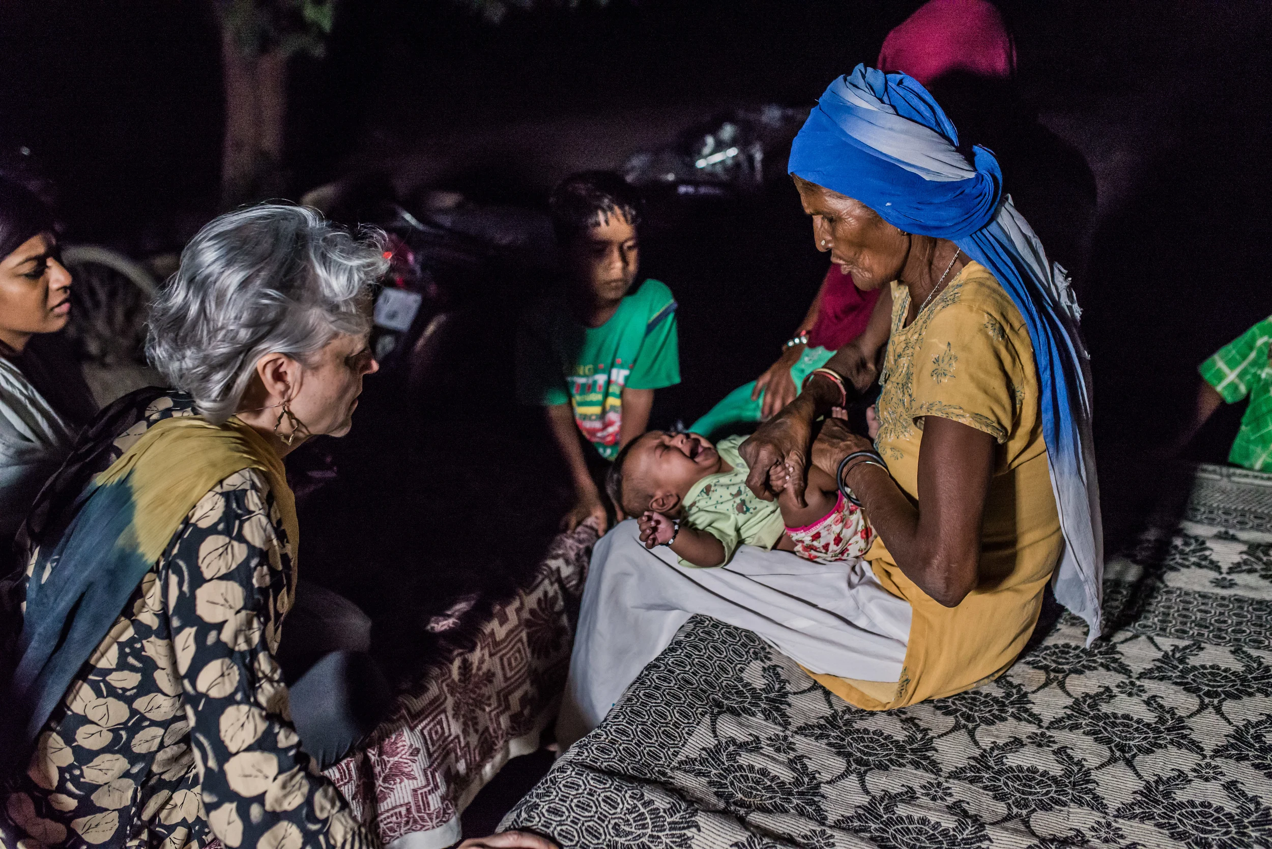 More than a midwife, Ram Rakhi is the first person village families come to when children are sick. This evening a grandmother brings her infant grandson to the midwife. After exchanging a few words, Ram Rakhi massages and makes adjustments to the child's position. Within a few minutes, the cries of pain subside and the baby rests in the dai's arms. “He will be fine now,” she says as she hands the baby back to his grandmother. Just another day in the life of this midwife.