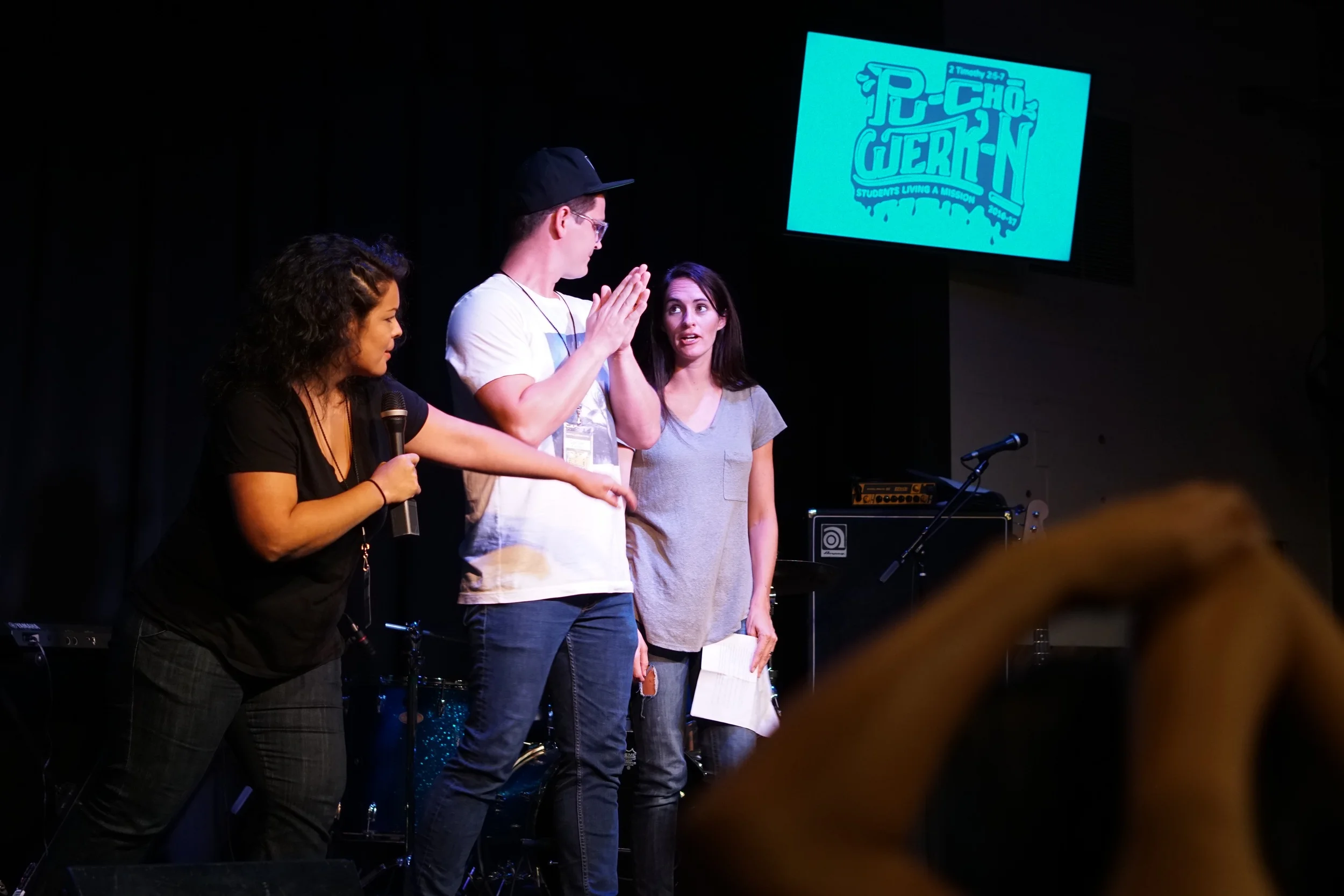 Deb Nava (left, mother of 2) and Tori Roufs (right, mother of 6) host Late Night, a time of entertainment for our SLAM participants as they wind down from days of service and Bible study. 