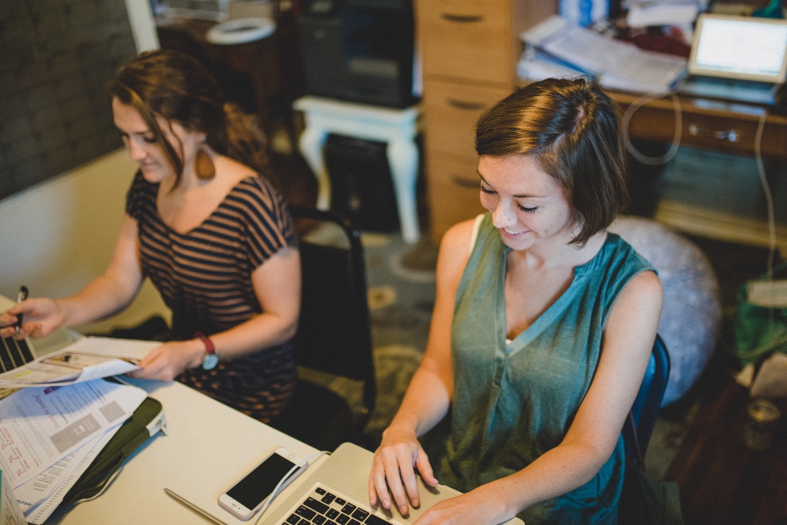 Laura is not the only one called to work behind-the-scenes. We are blessed with a committed team of administrators that help our work run effectively and efficiently in each of our regions. Here, Brittany Girton and Leah Sherrod work administratively to organize our maternal health efforts. 