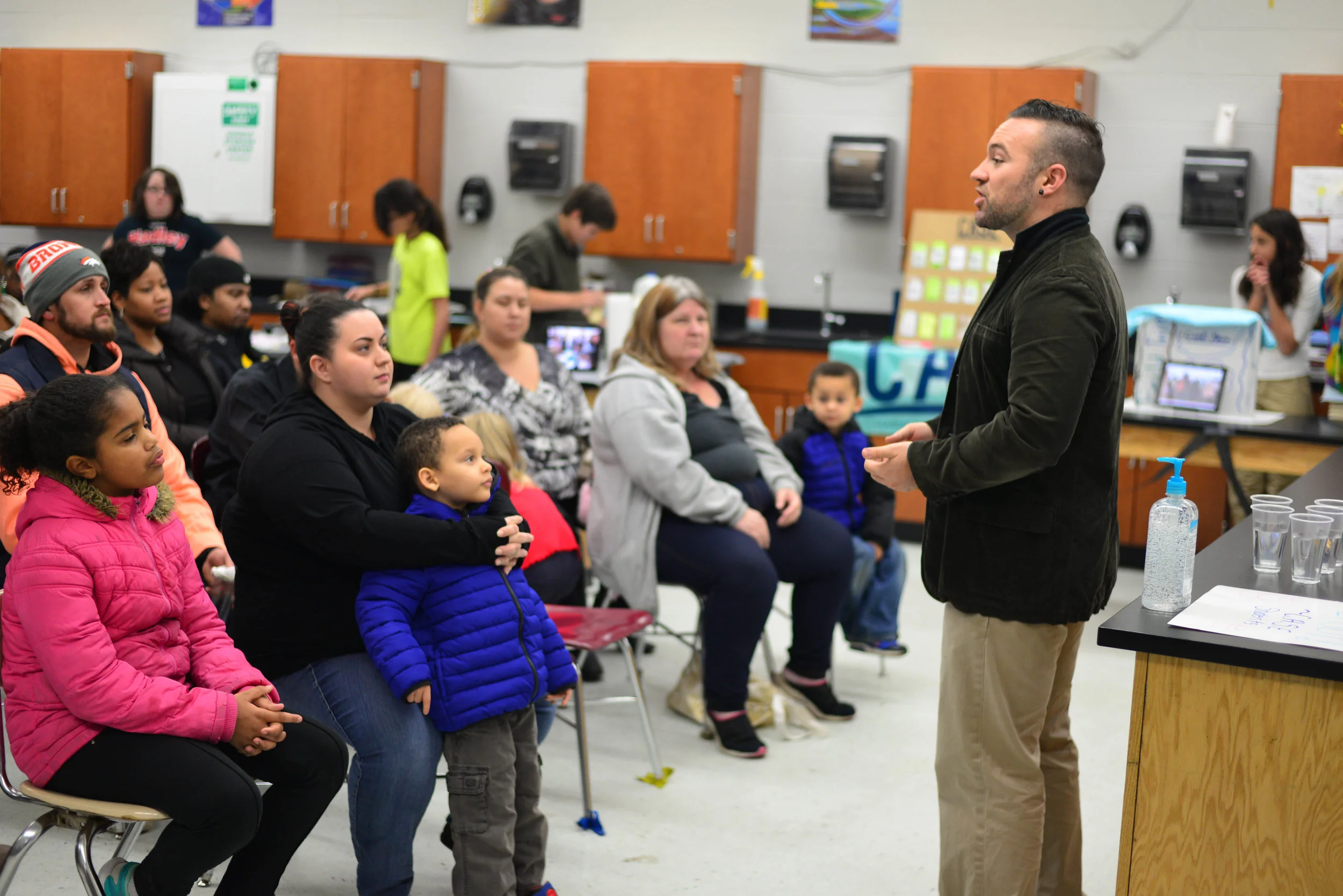 Dupont Hadley Site Coordinator Craig Duffy speaks with parents of C.A.S.E. students at the ShowCASE, where students are able to put on display the skills they have learned over the course of the semester. 