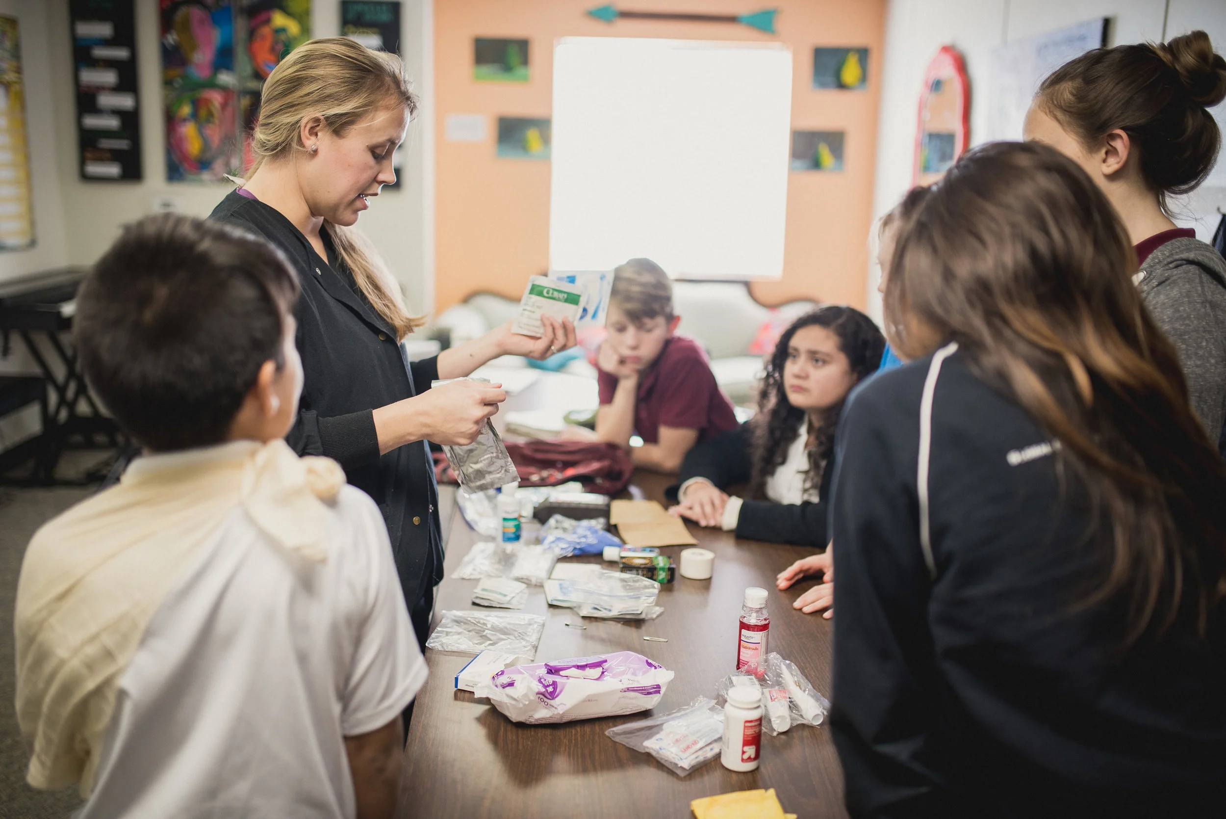 Amanda teaches a first aid class to middle schoolers at the Academy for G.O.D.
