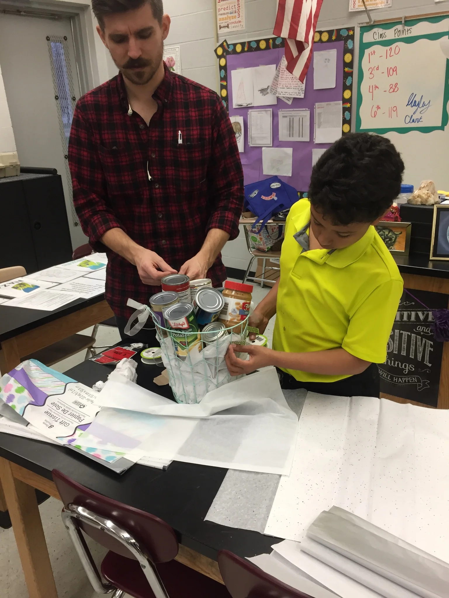 Facilitator Josh Nava works with students as they decorate the baskets to be sent to the families. 
