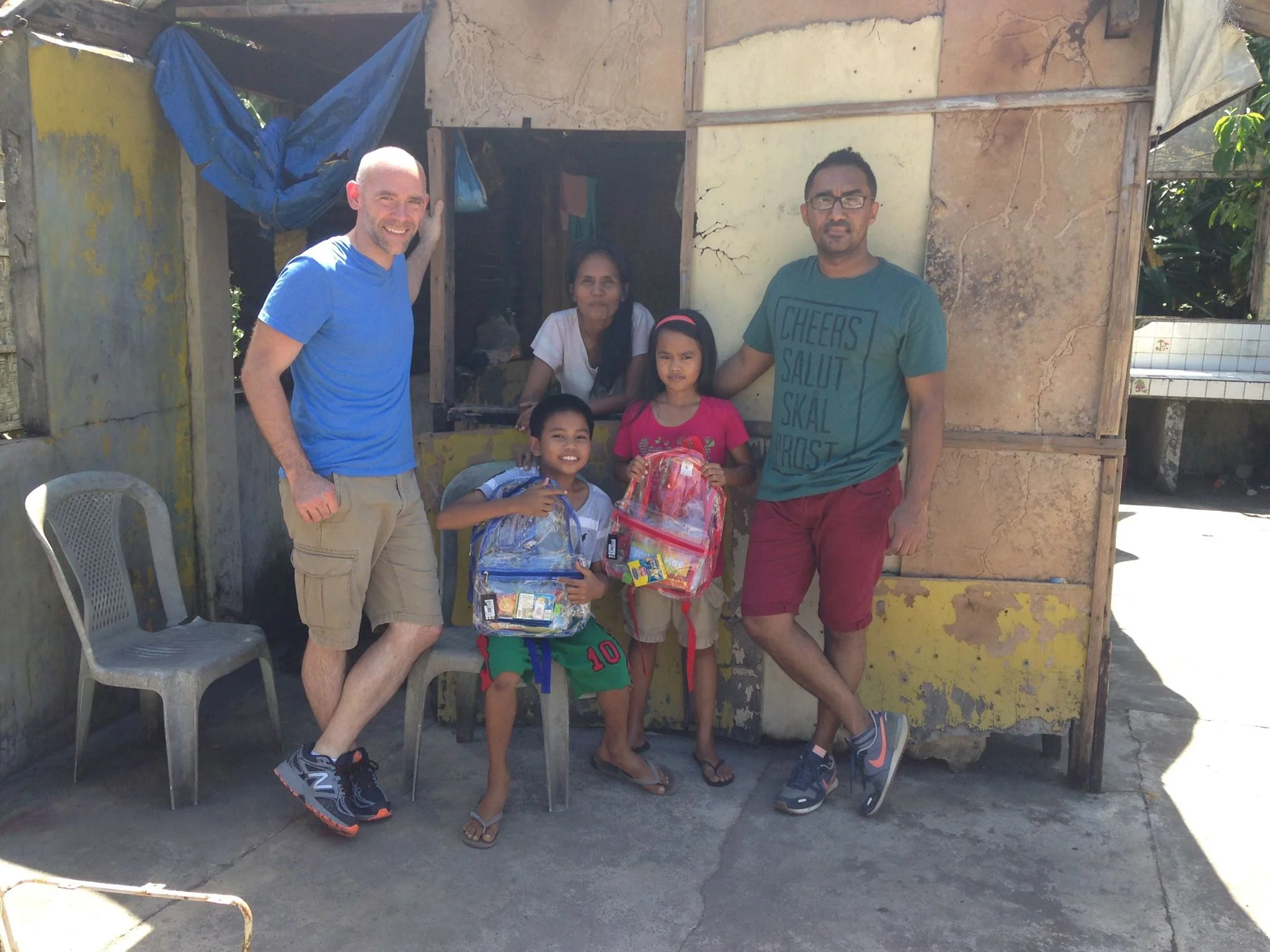 Keith and his friend Mo delivering some school supplies to a family of children in need in the neighborhood. 