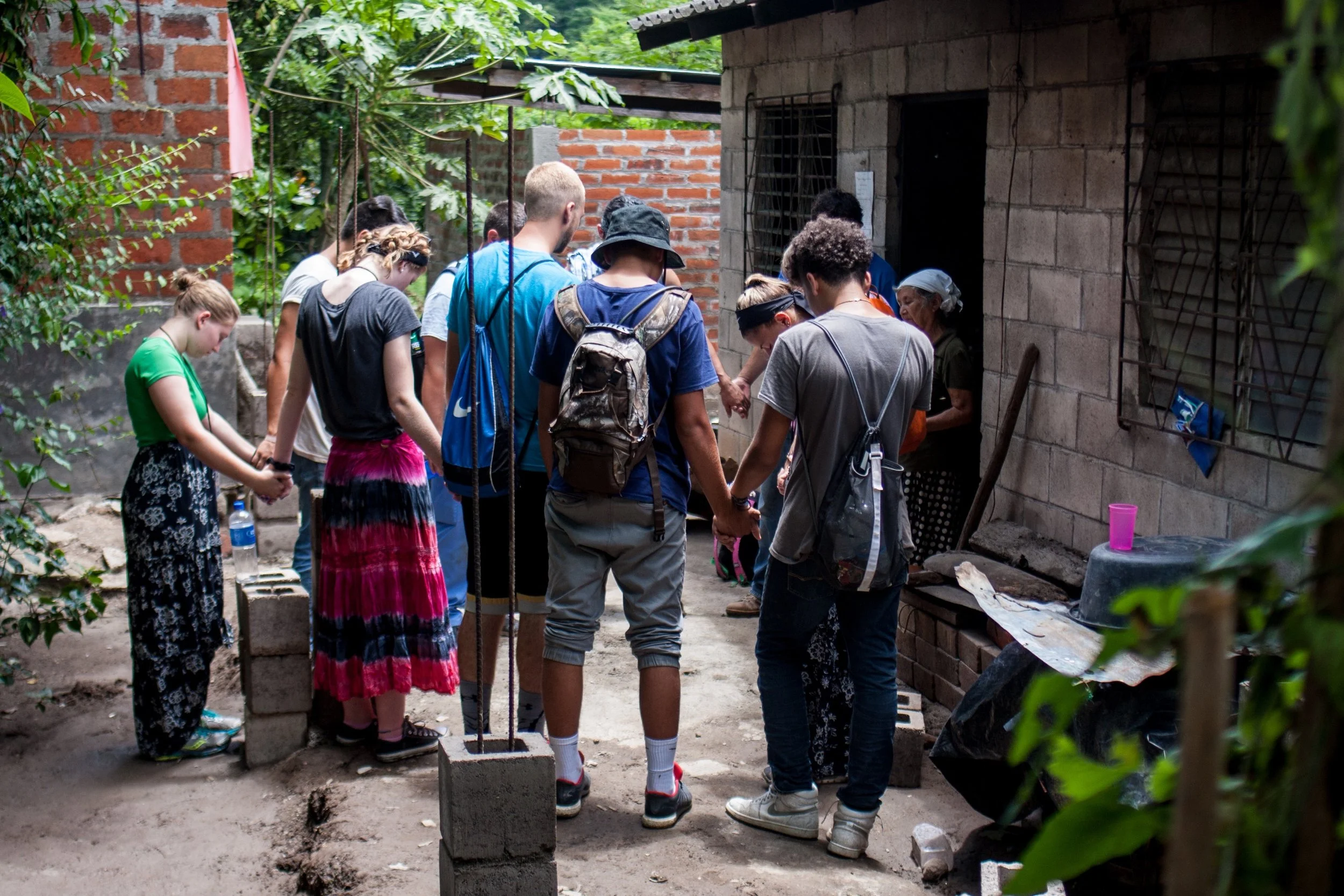 This group prays for Maria, a woman with skin cancer who is awaiting her second surgery, while she cares for two 10-year-old girls. The team repaired her porch roof, which was held up by an unstable tree trunk.