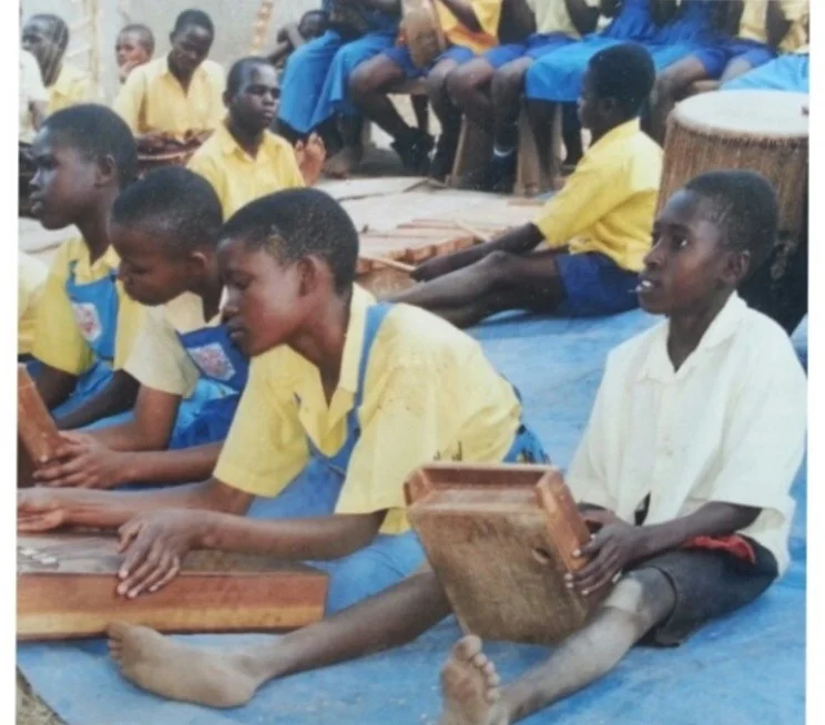 Moses Ssekabira, far right, made his way through primary school largely due to his musical ability. 