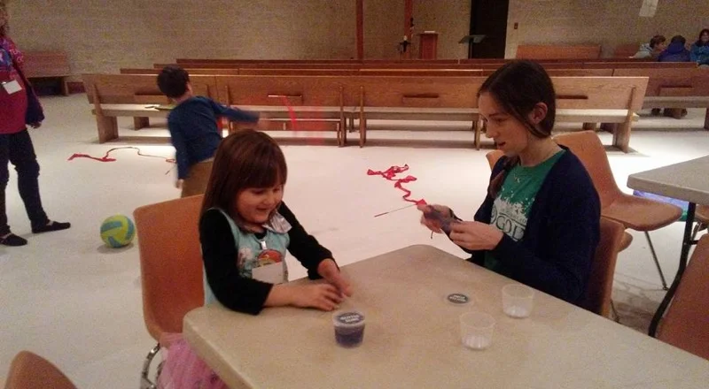 Merci Warren, Academy for G.O.D. freshman, helps with an arts and crafts activity during Buddy Break. She says, "I've loved serving kids and giving them a great time!" 