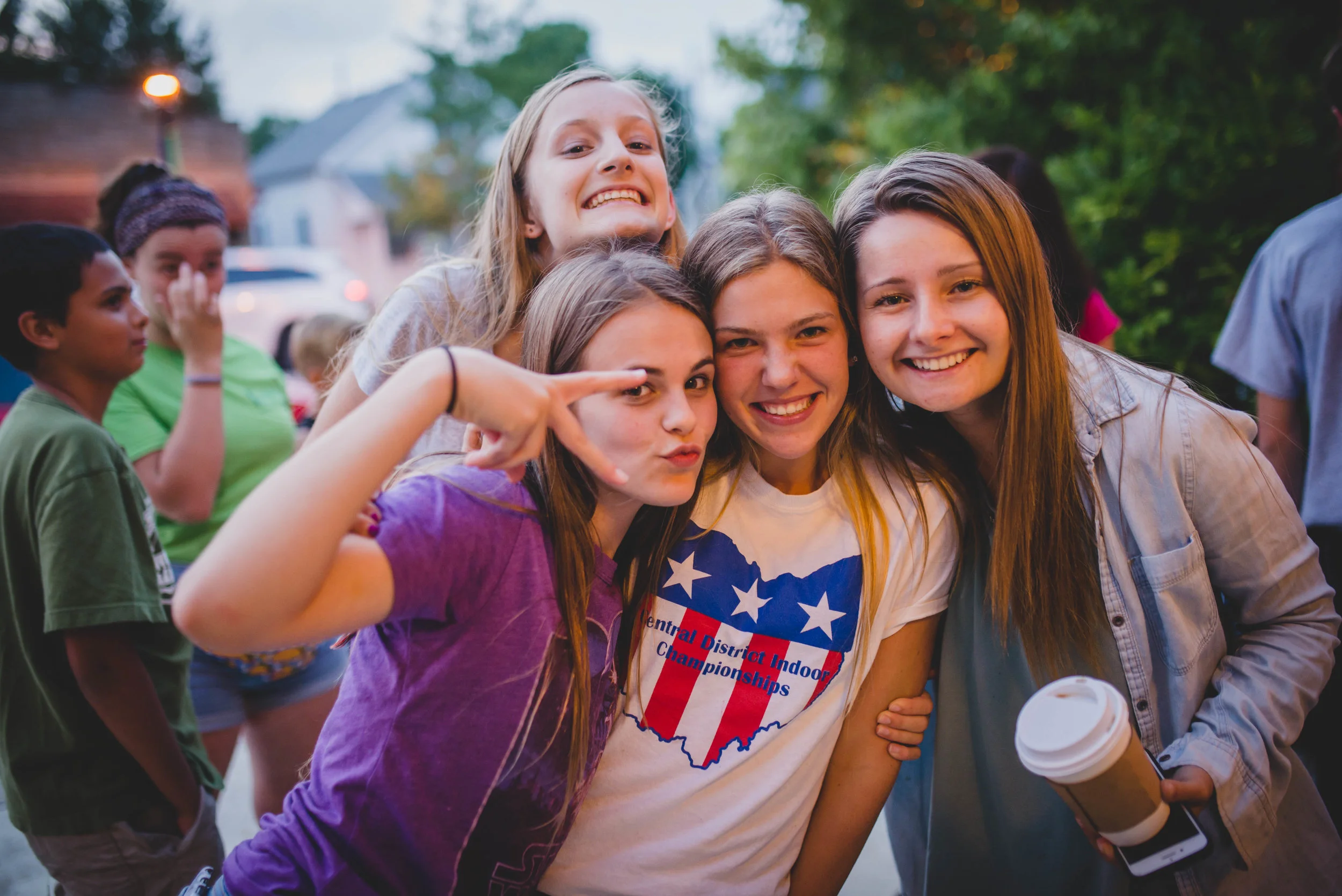 Institute student Josie Lyn (right) poses with students she bonded with during SLAM small groups right before they kicked off an epic Late Night game. 
