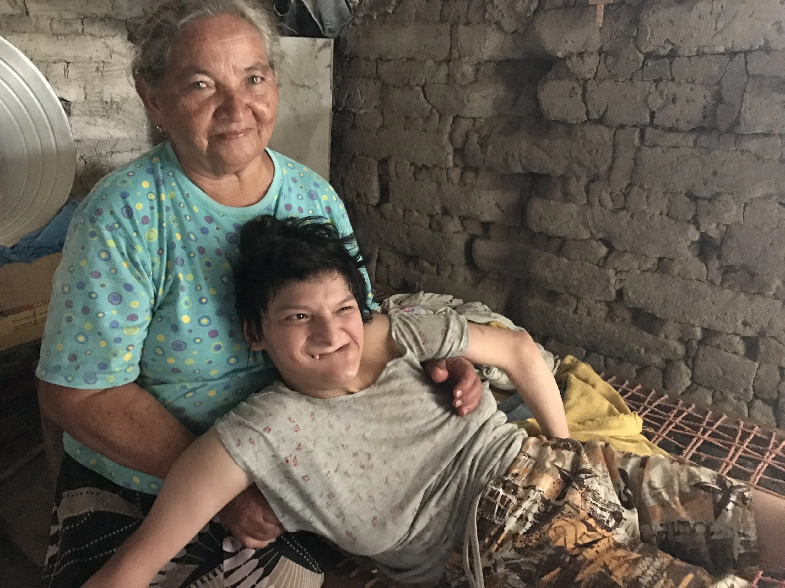 Antonia, a widow in her 70s, cares for her daughter, Angelita, who has cerebral palsy. The interns visited with them, bringing them food and songs.
