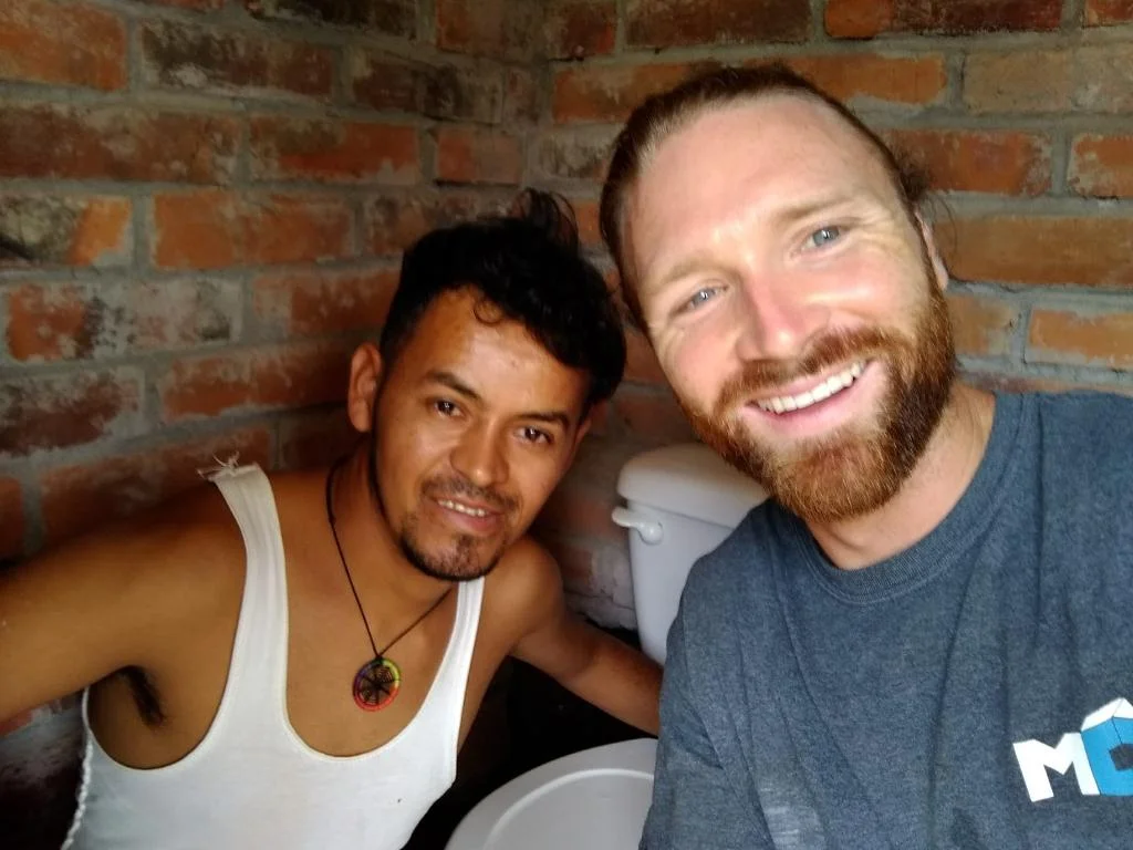 Kyle and Miguel successfully completed the renovation of a public bathroom, despite their language barrier. 