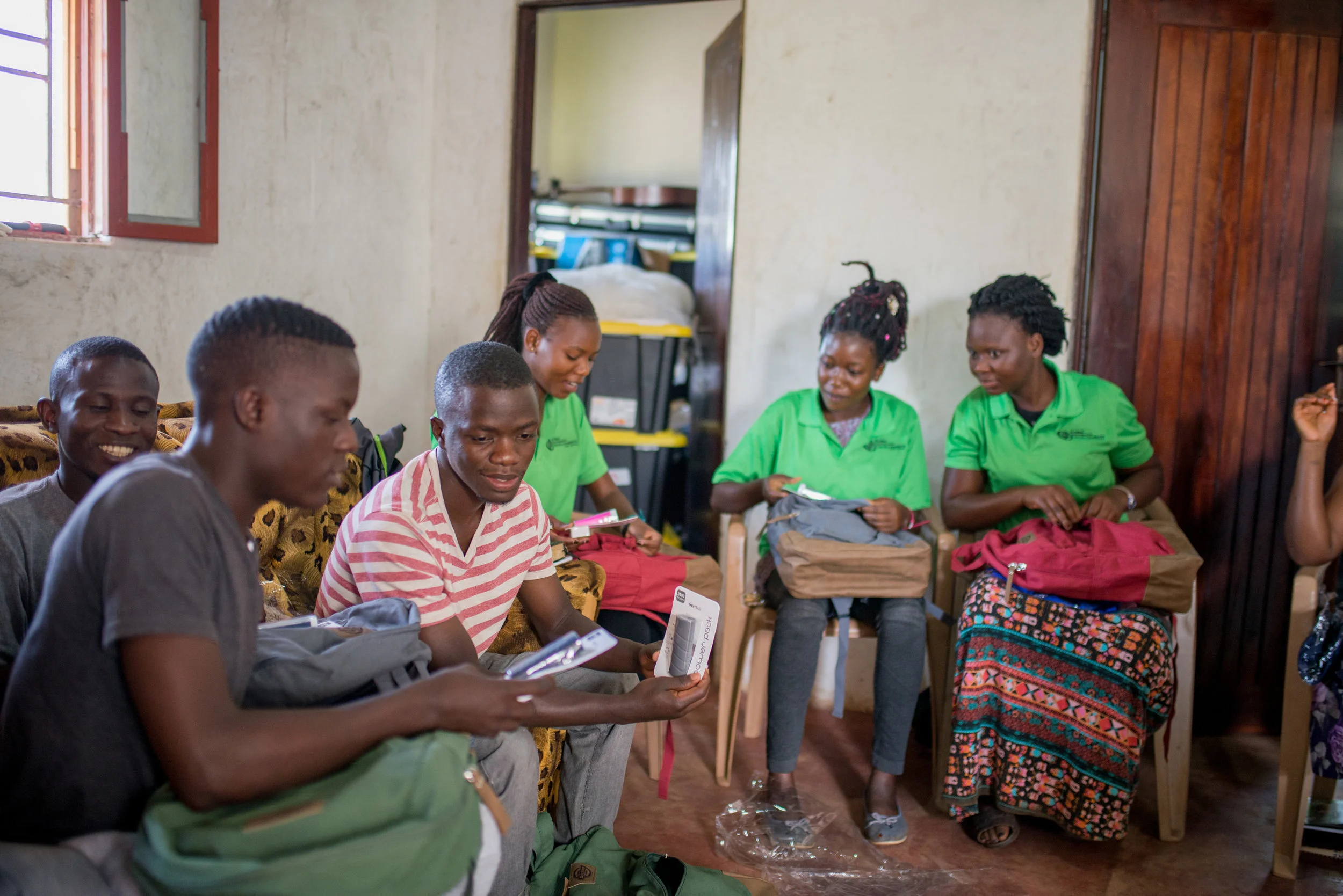 Students at the Institute for G.O.D. East Africa look over gifts that had just been distributed to them: backpacks, embroidered polos, pens and books —necessities to accompany the gift of tuition already supplied to them.