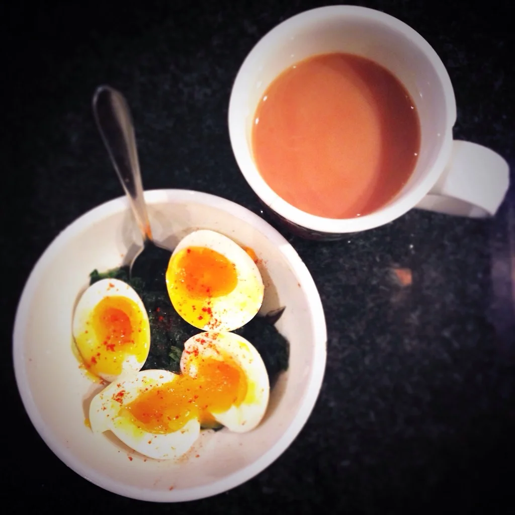 Soft-boiled eggs and steamed spinach with salt and paprika and a cup of tea.