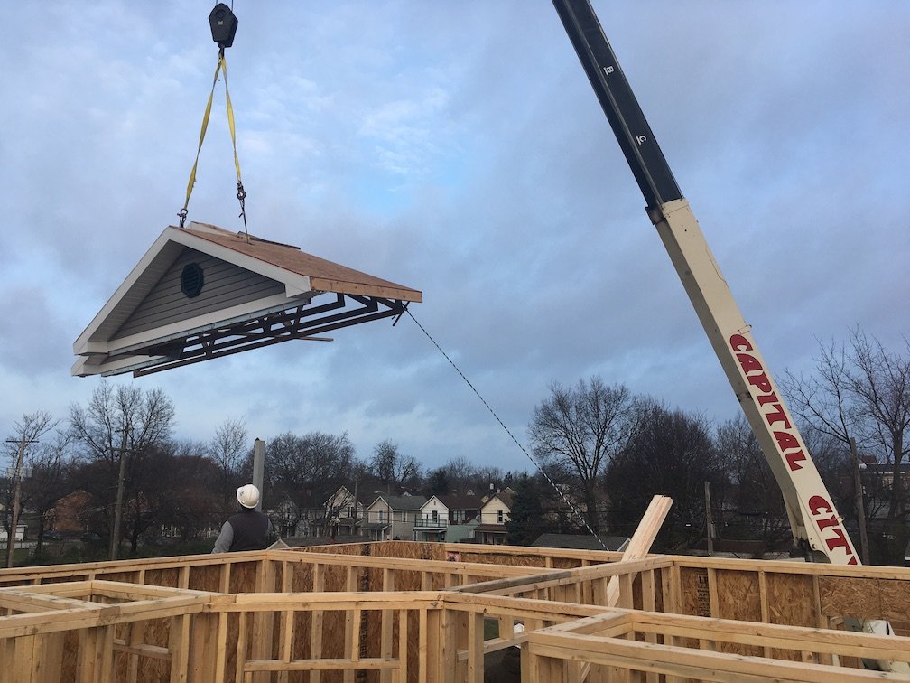  Gable end trusses installed as a package on the ground before being lifted into place by a crane. 