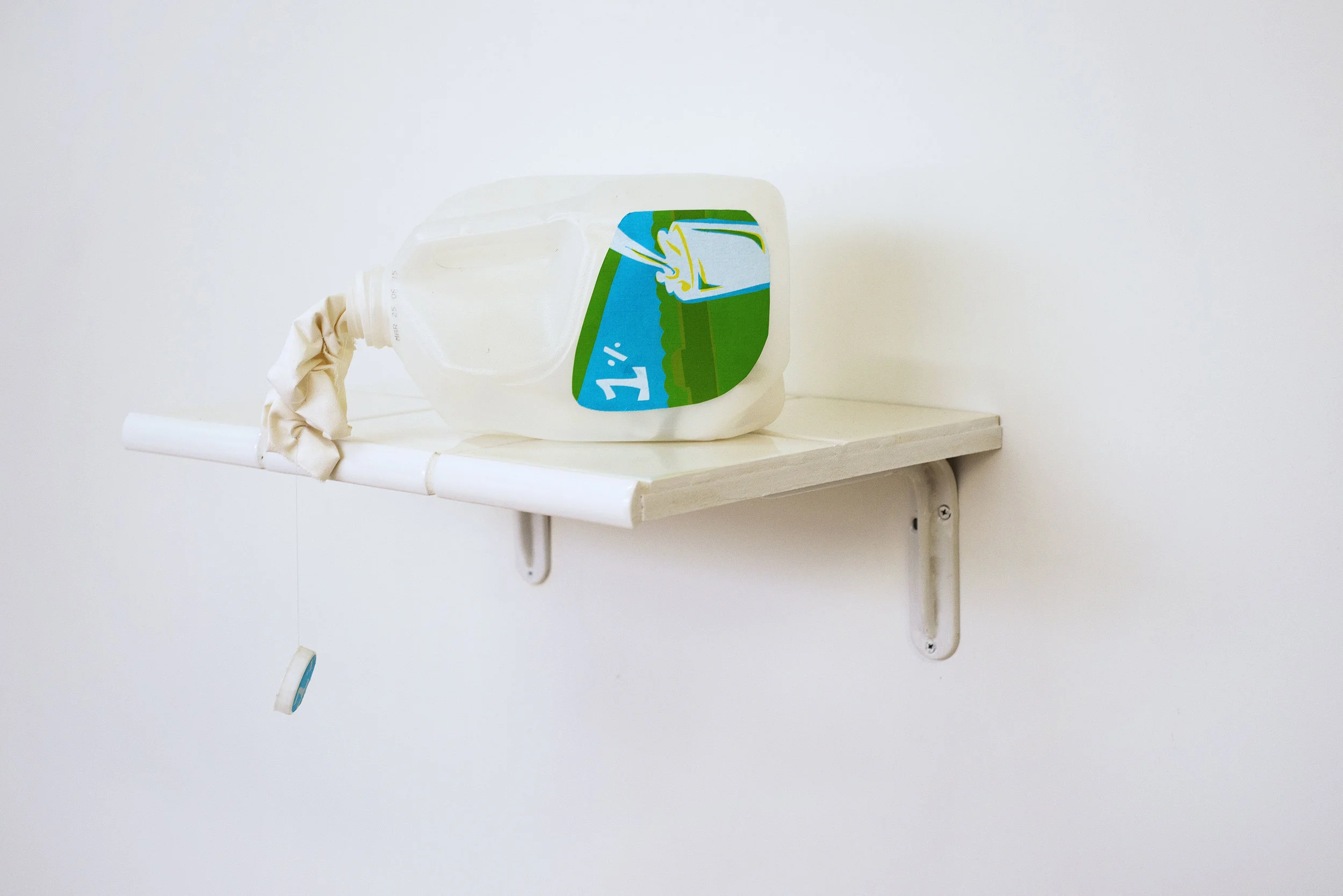 "Splittin'", 2016, Screen-printed fabric, 1-gal milk jug, blackout fabric, tile, grout, MDF