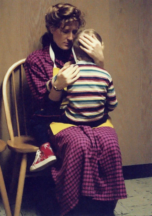 my crying son being comforted by his mother after tumbling down a flight of stairs at his home (1989)