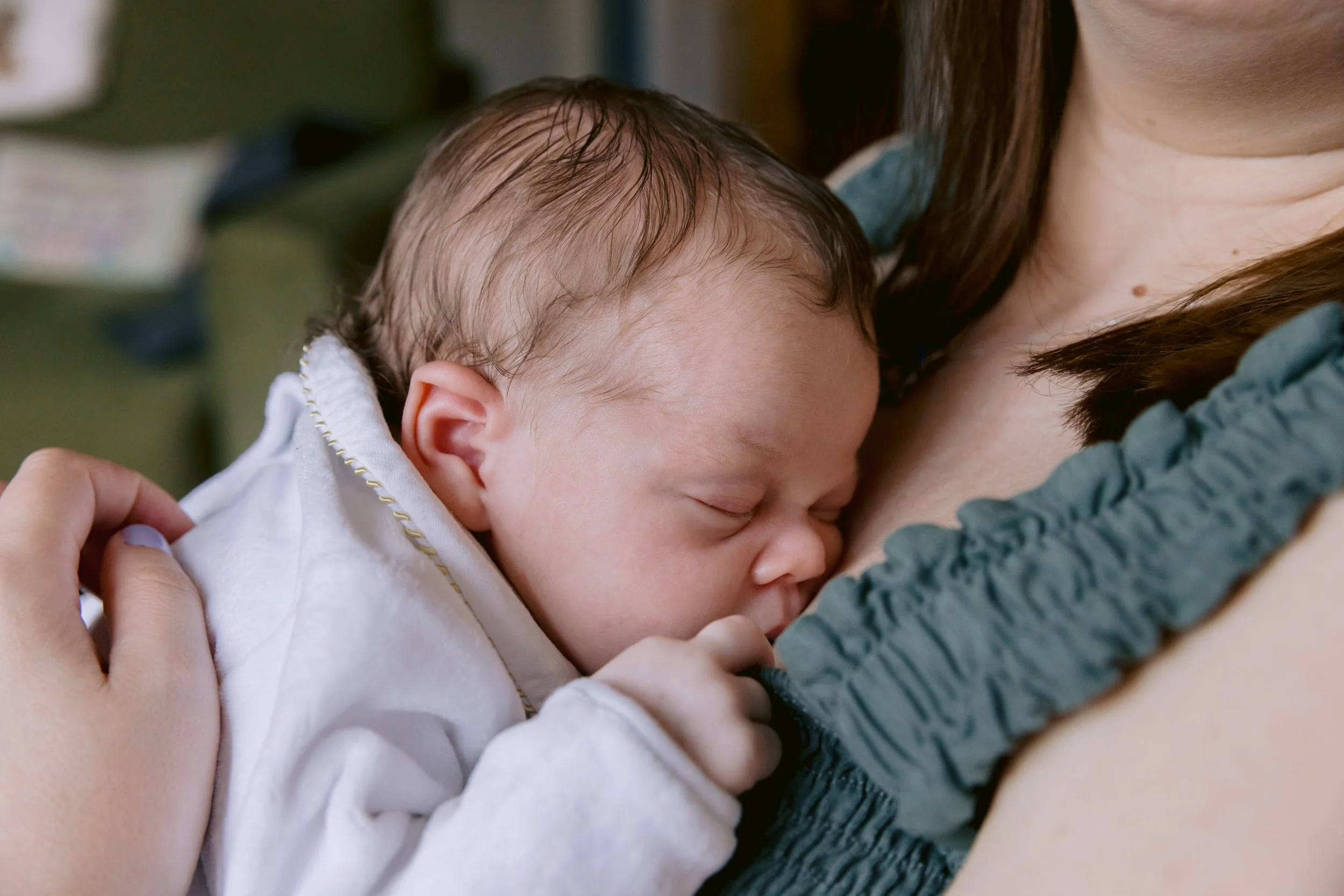 Baby sleeping on mum during a newborn photo session in South West London