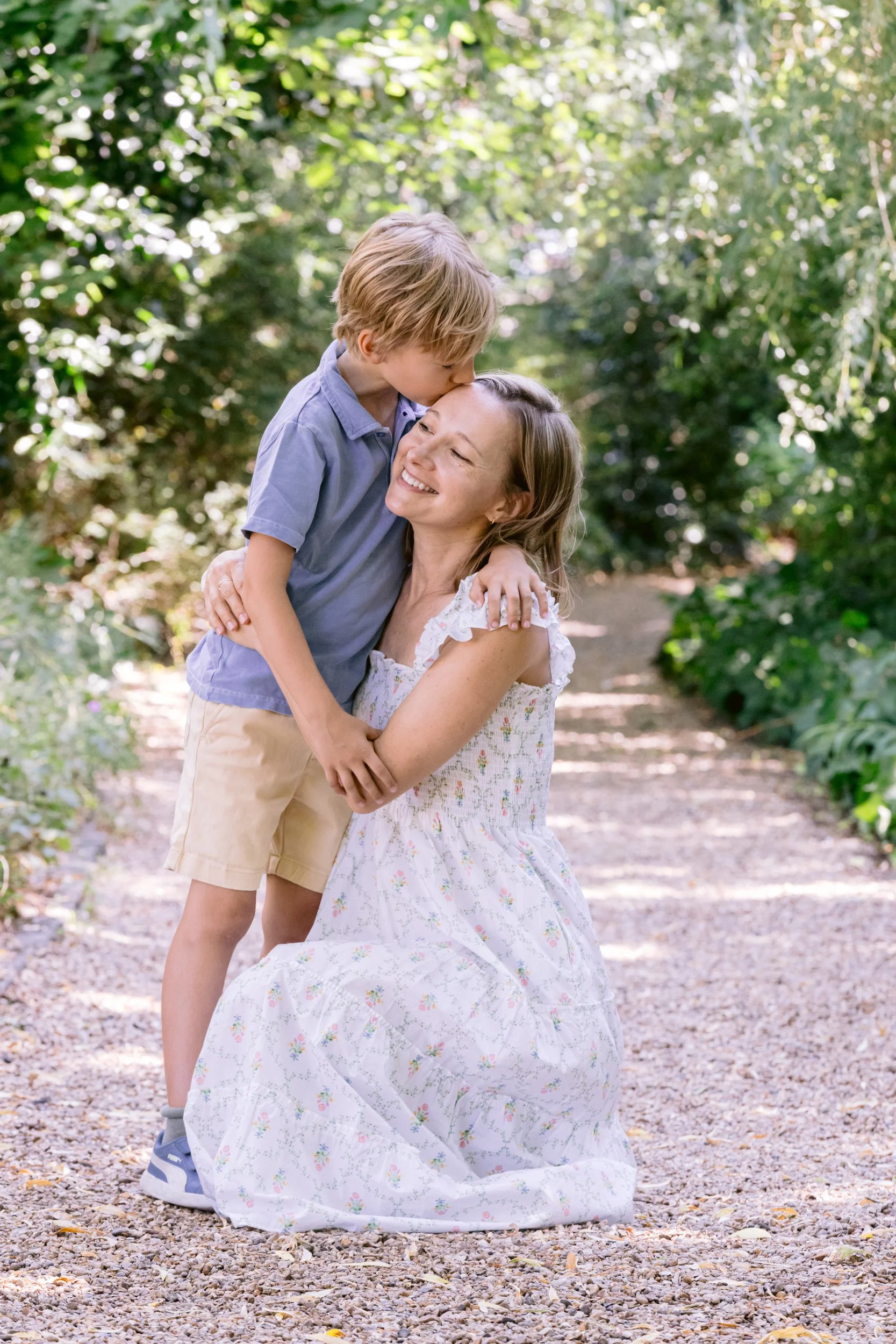 Boy kisses his mum during a family photoshoot in Notting Hill, London