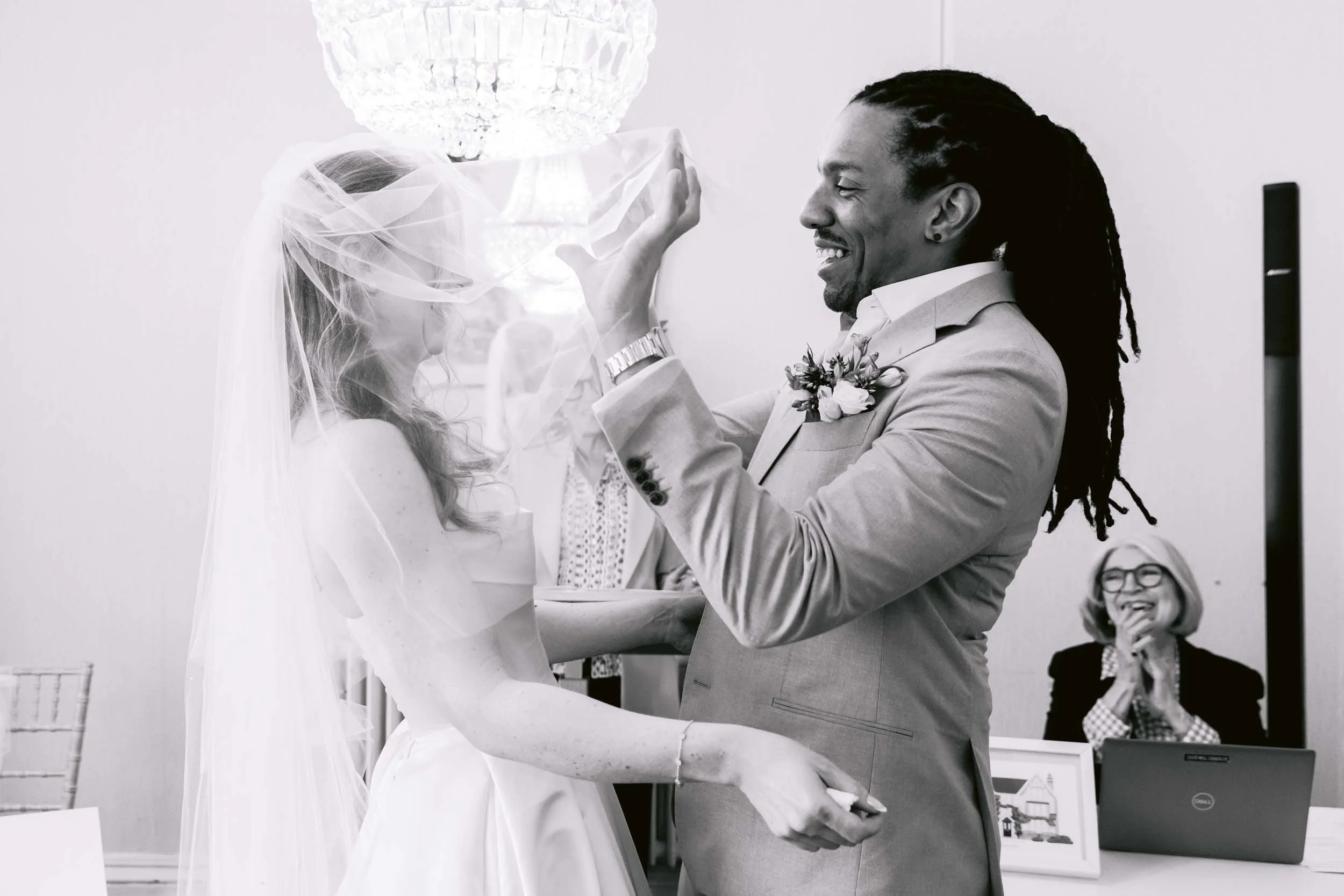 bride and groom share the first kiss at an intimate wedding ceremony at artington house in guildford