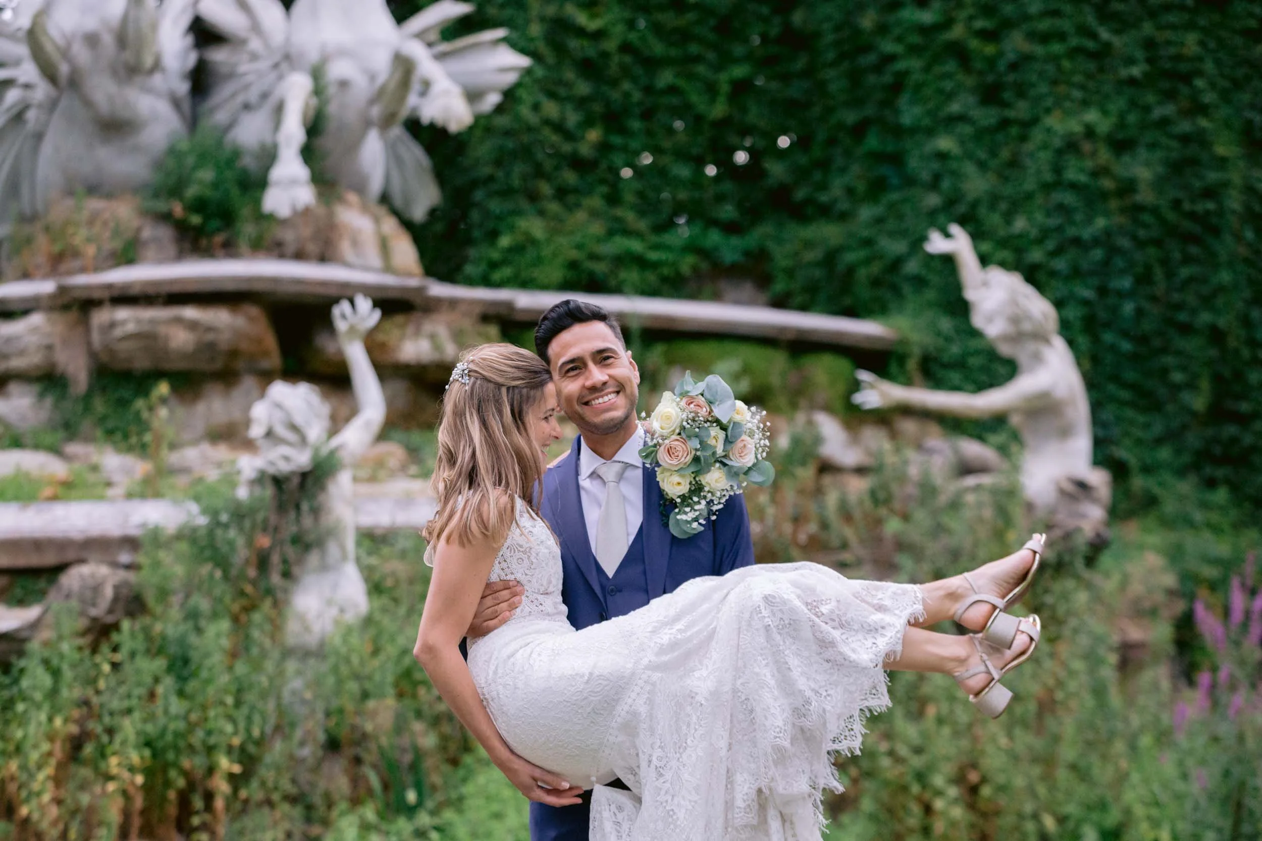 Wedding couple having a laugh in front of the nymph fountain at York House in Twickenham