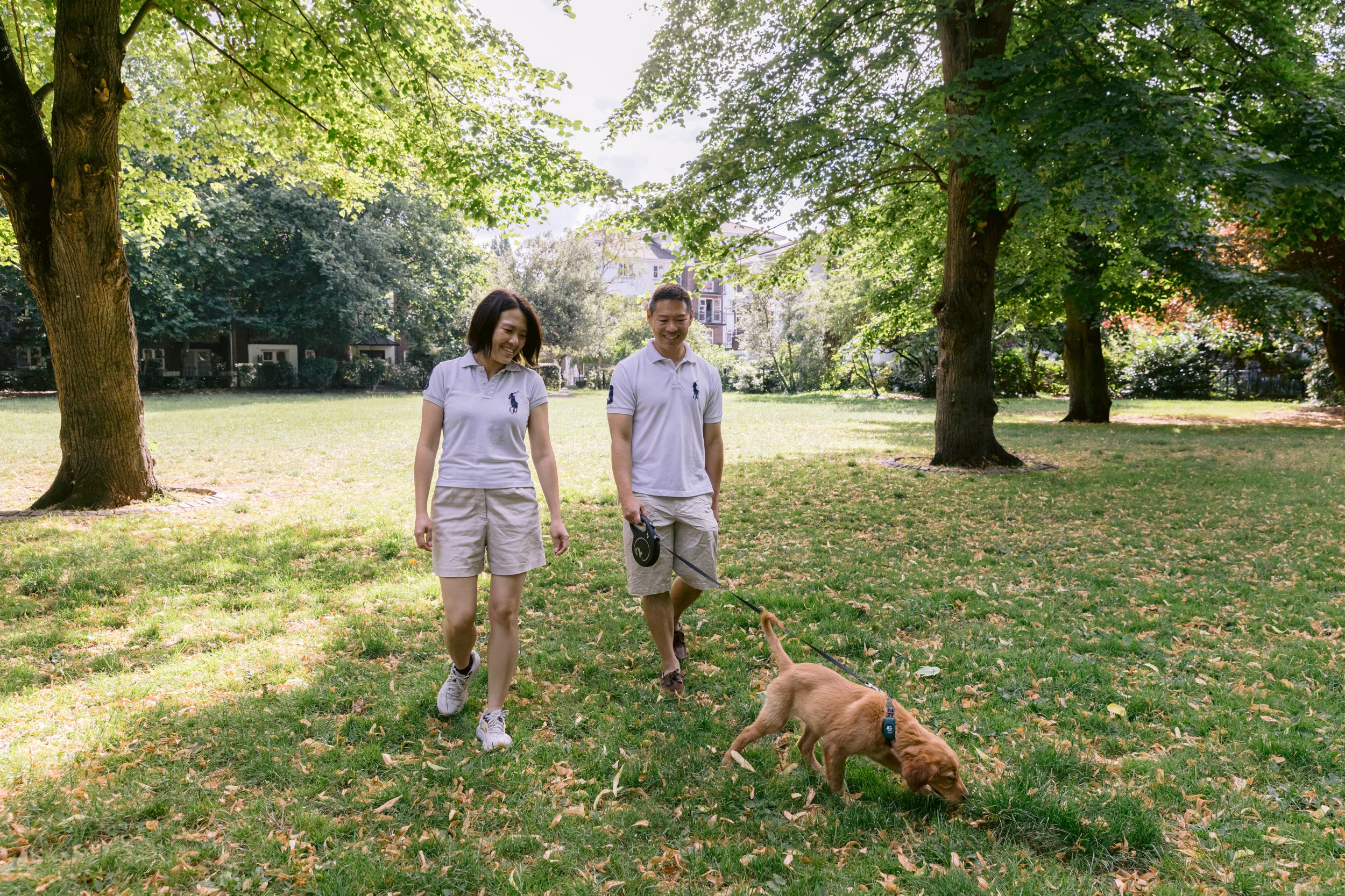 Couple walking their puppy in London during a photo session