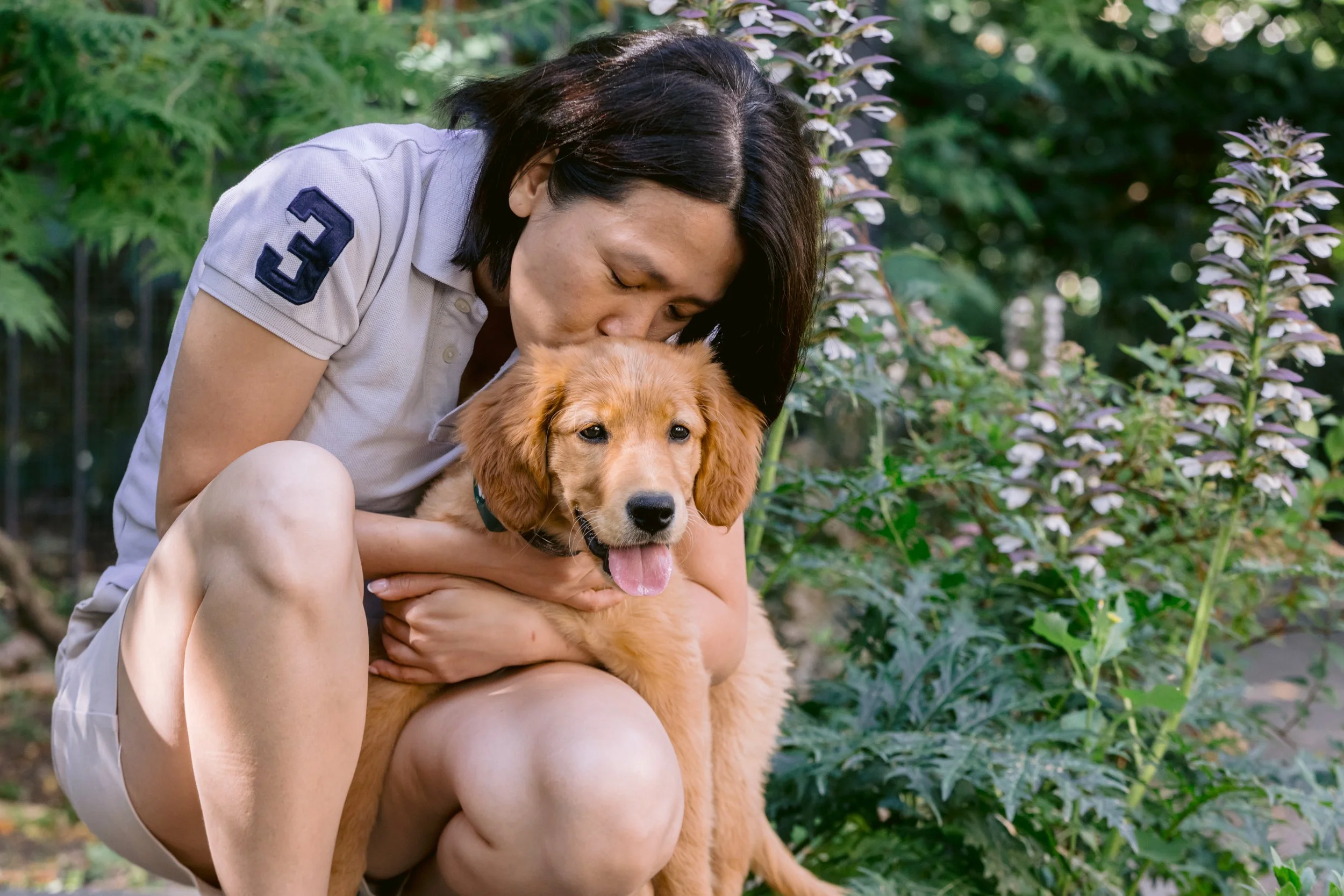 Woman kissing her puppy during a photoshoot in London
