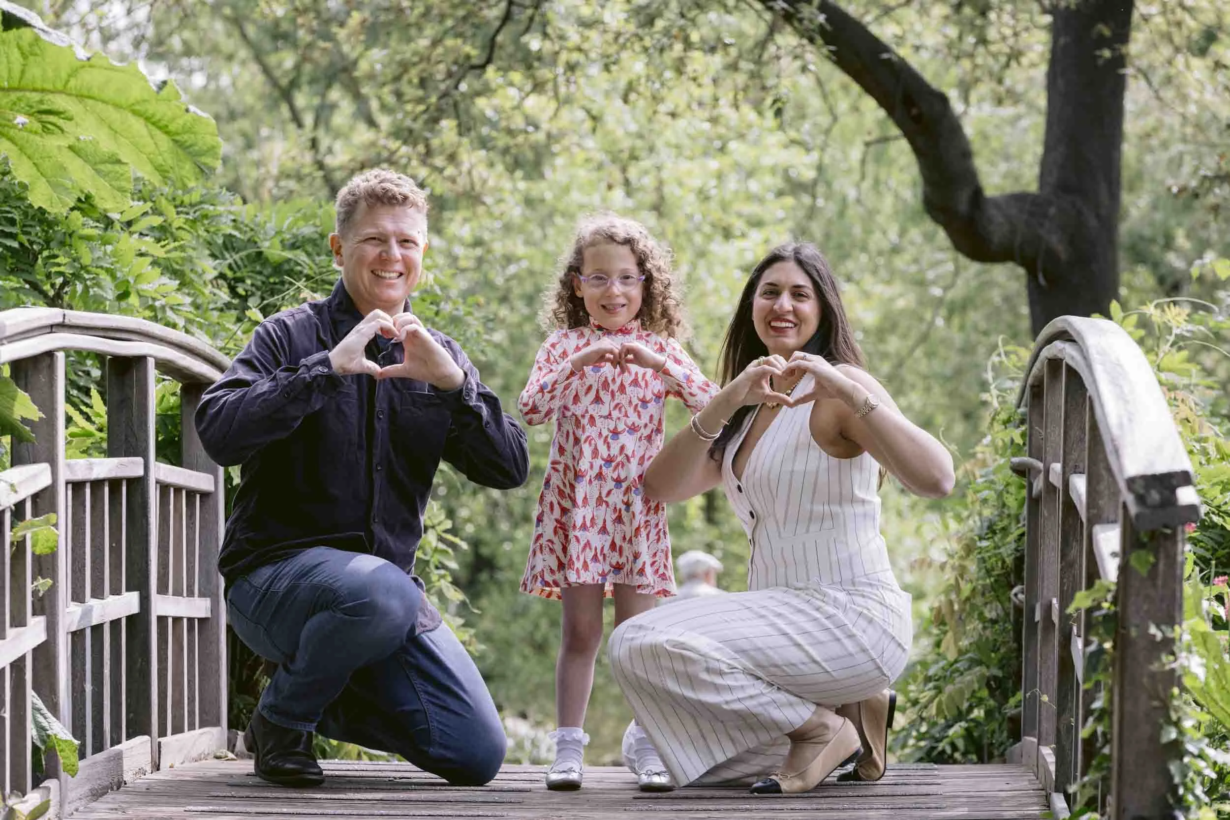 A relaxed family photoshoot in Richmond Park featuring a mother and children playing in nature.