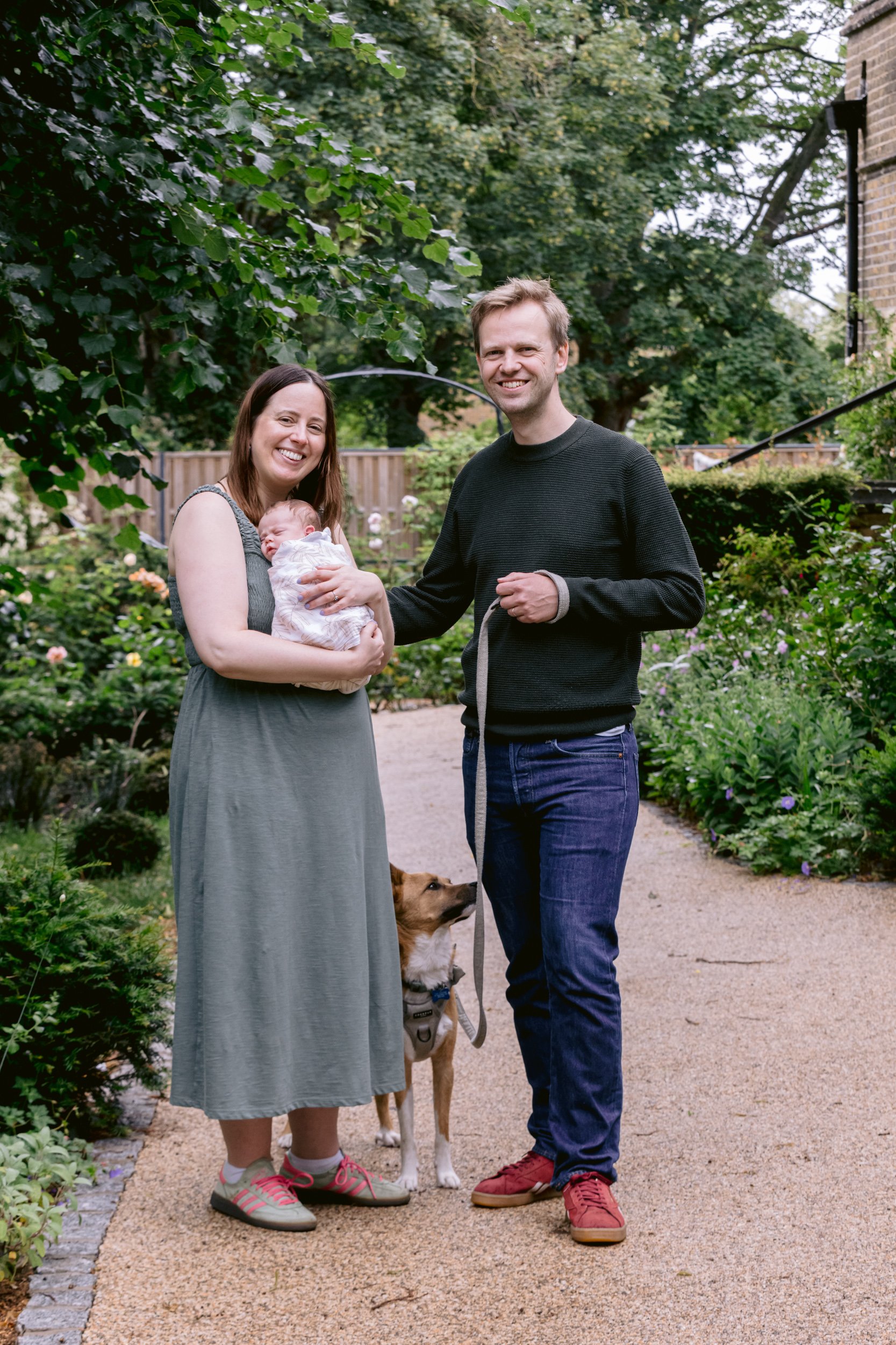 Family portrait with new baby and dog during a newborn and dog photo session in South West London
