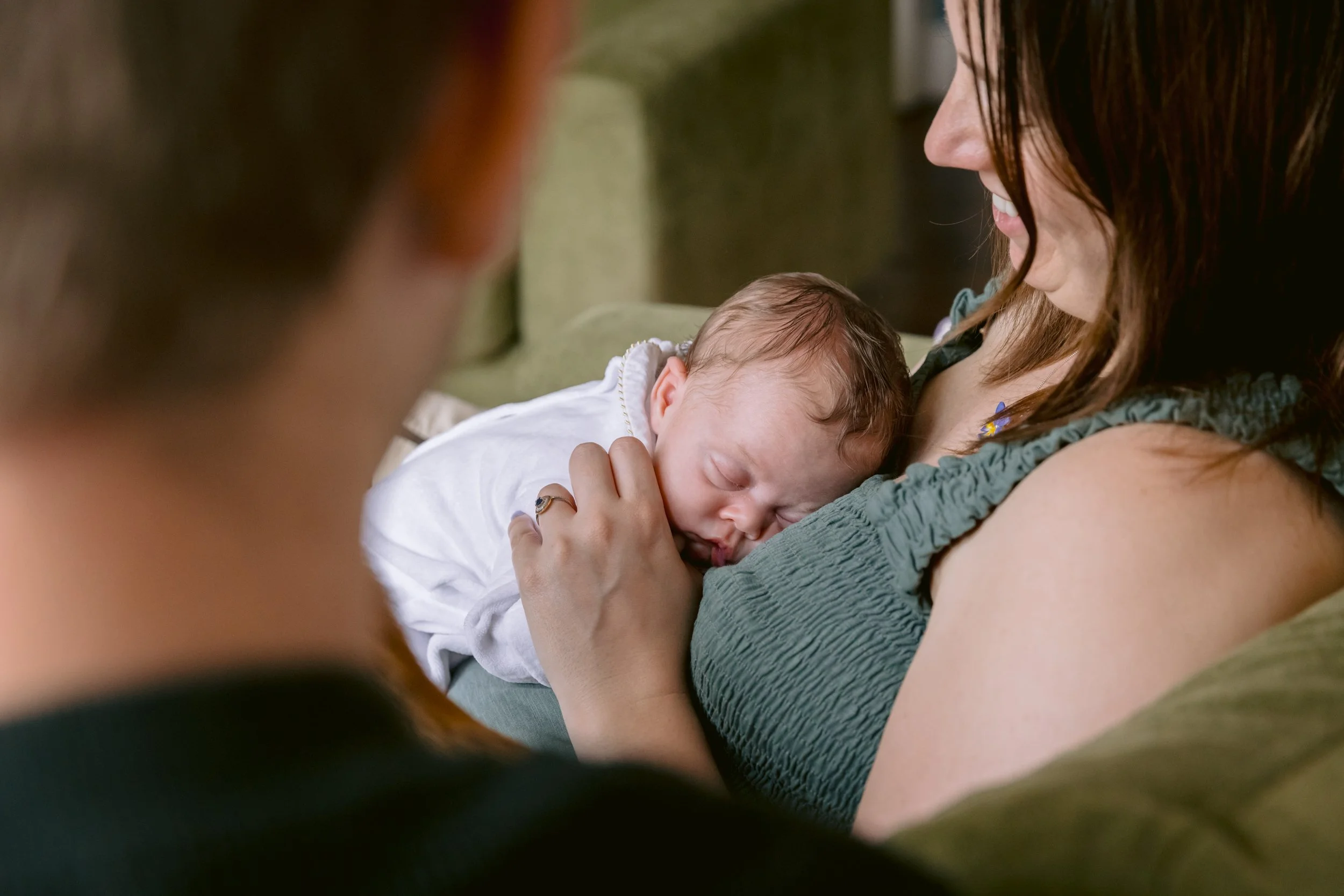 Baby sleeping while mum and dad looking lovingly