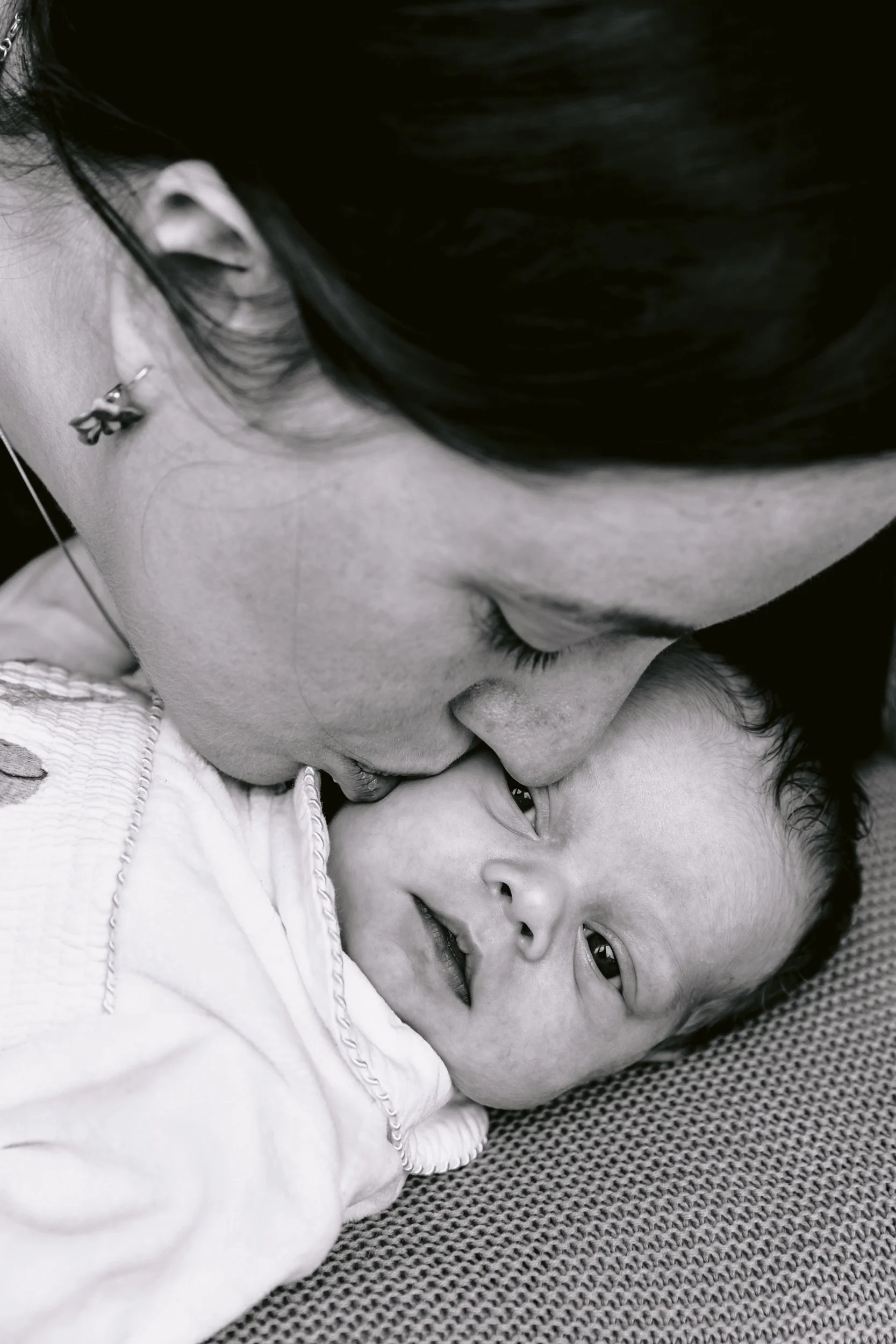 Mum kissing baby during a newborn photo session in South West London