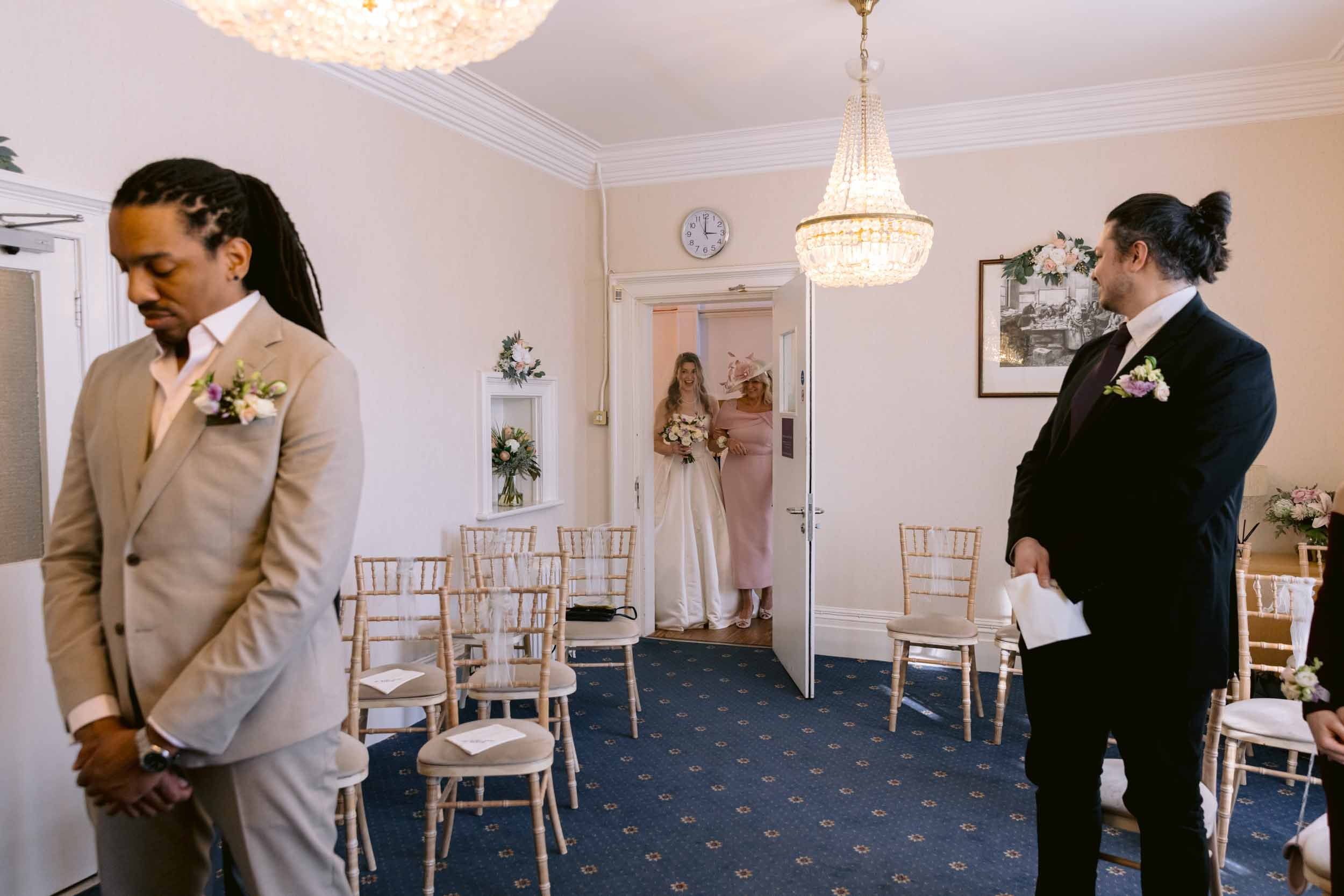 Interior view of the elegant, light-filled ceremony room at Artington House, Guildford Register Office, set up for a small civil wedding.