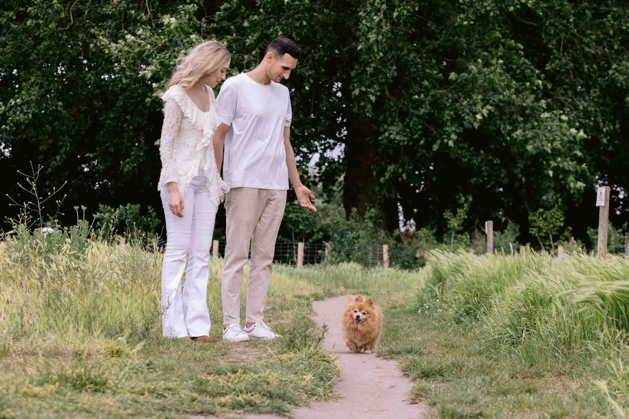 Couple and dog walking on Clapham Common