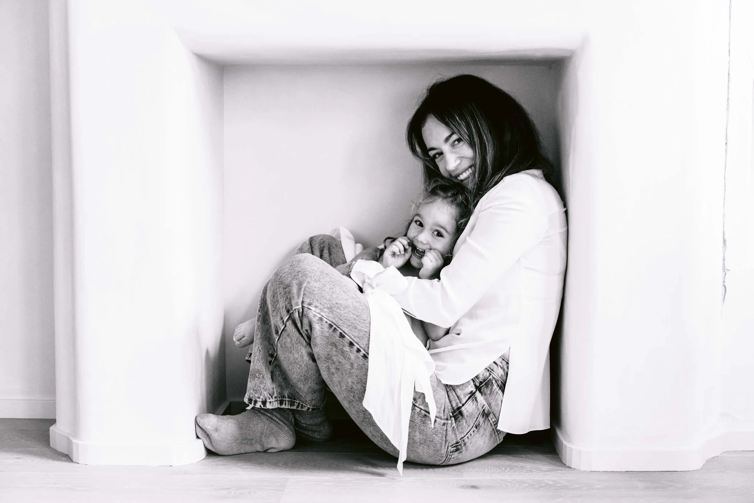 Mother holding her daughter during a family photoshoot a meaningful Mother's day gift