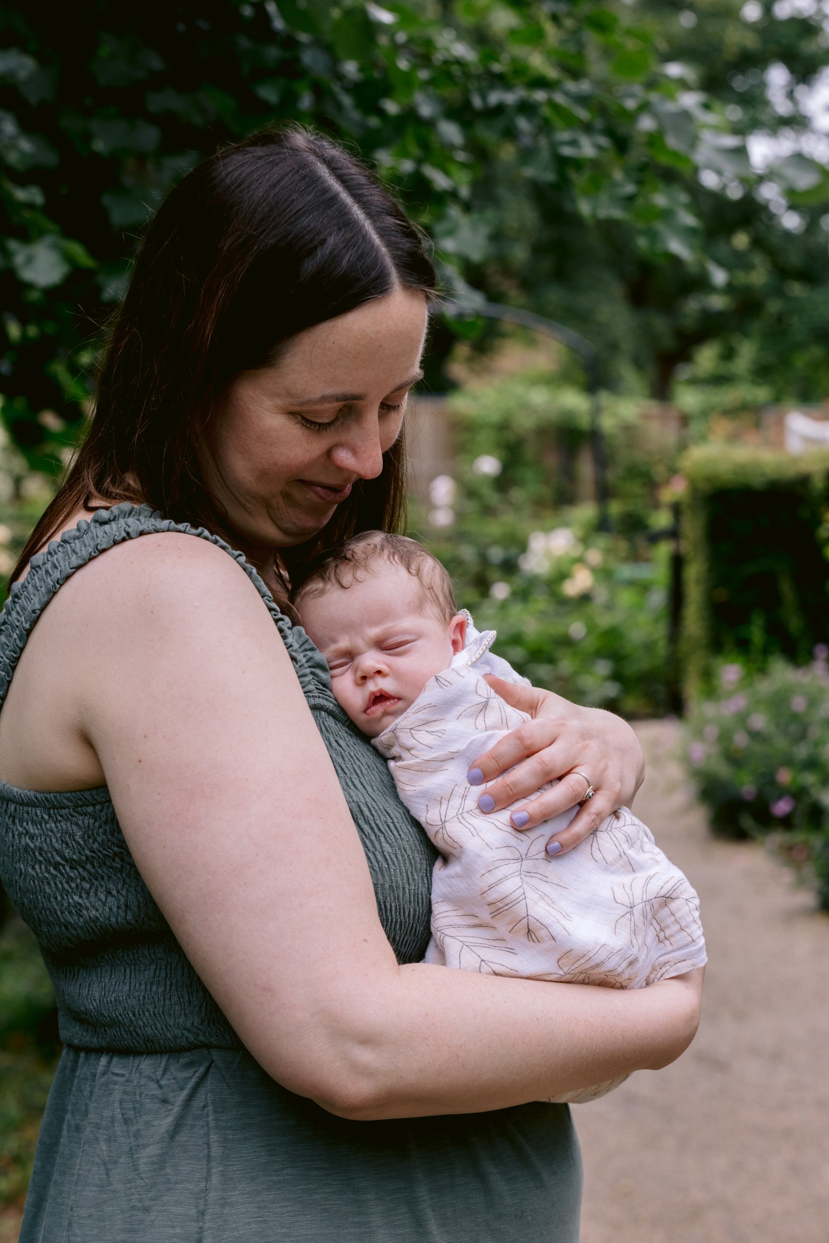 Mum cuddling baby during an outdoor newborn photo session in Putney