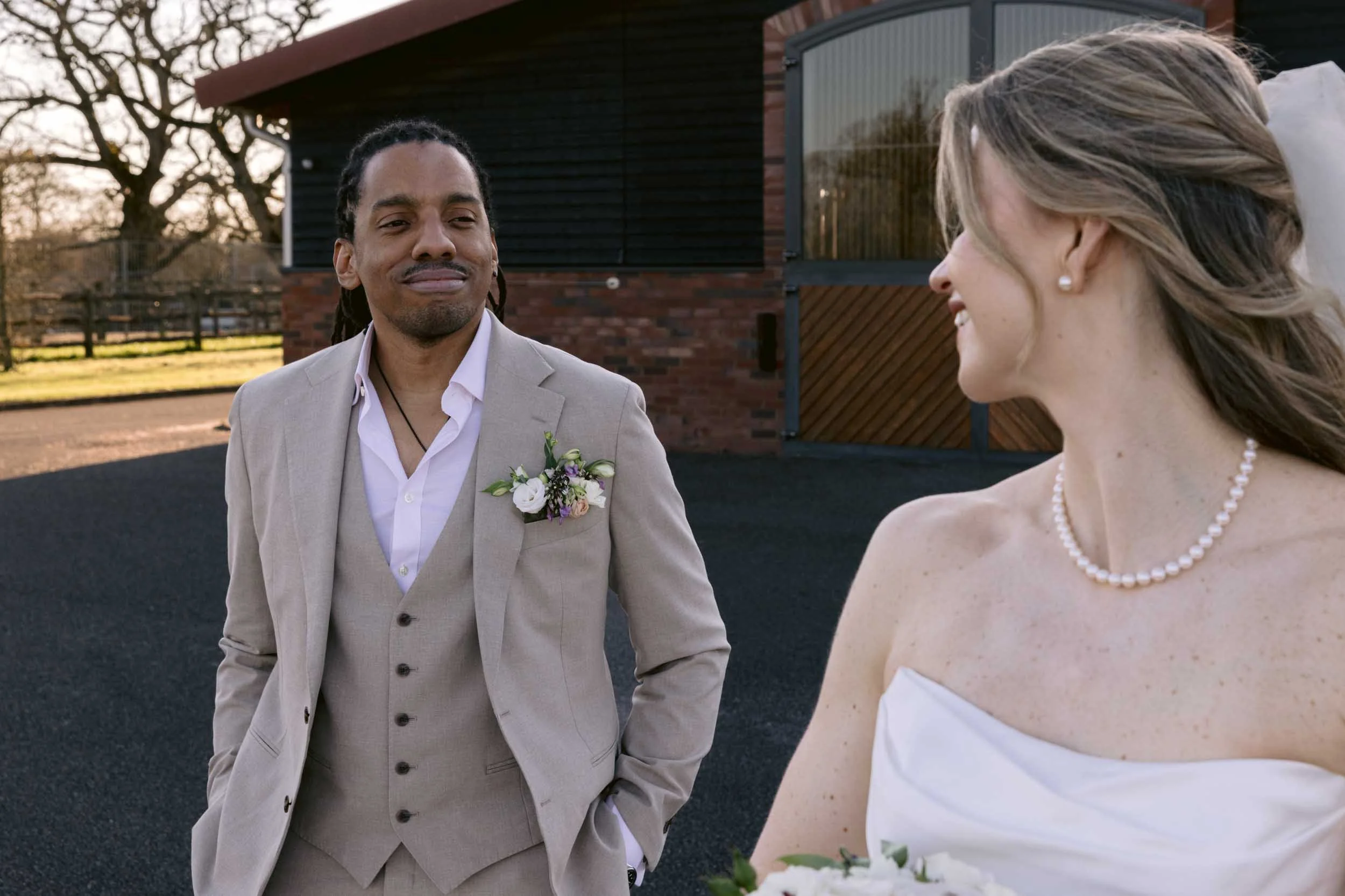 A documentary-style wedding photograph capturing a quiet, meaningful interaction between the couple at their Surrey wedding.