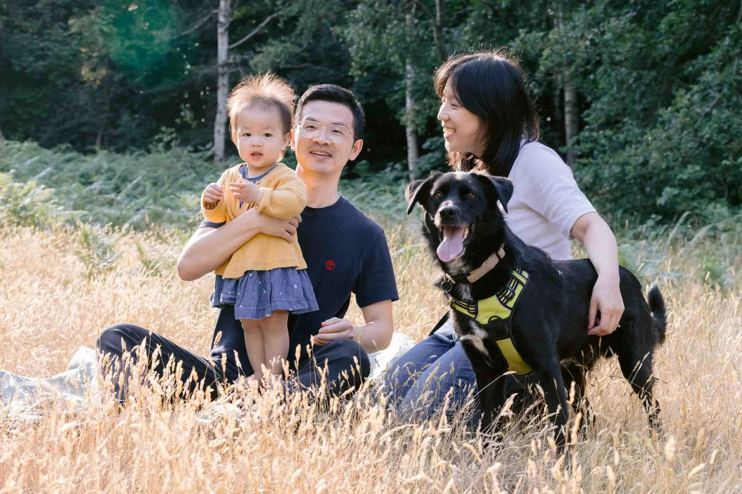A family sharing a quiet moment with the family dog outdoors