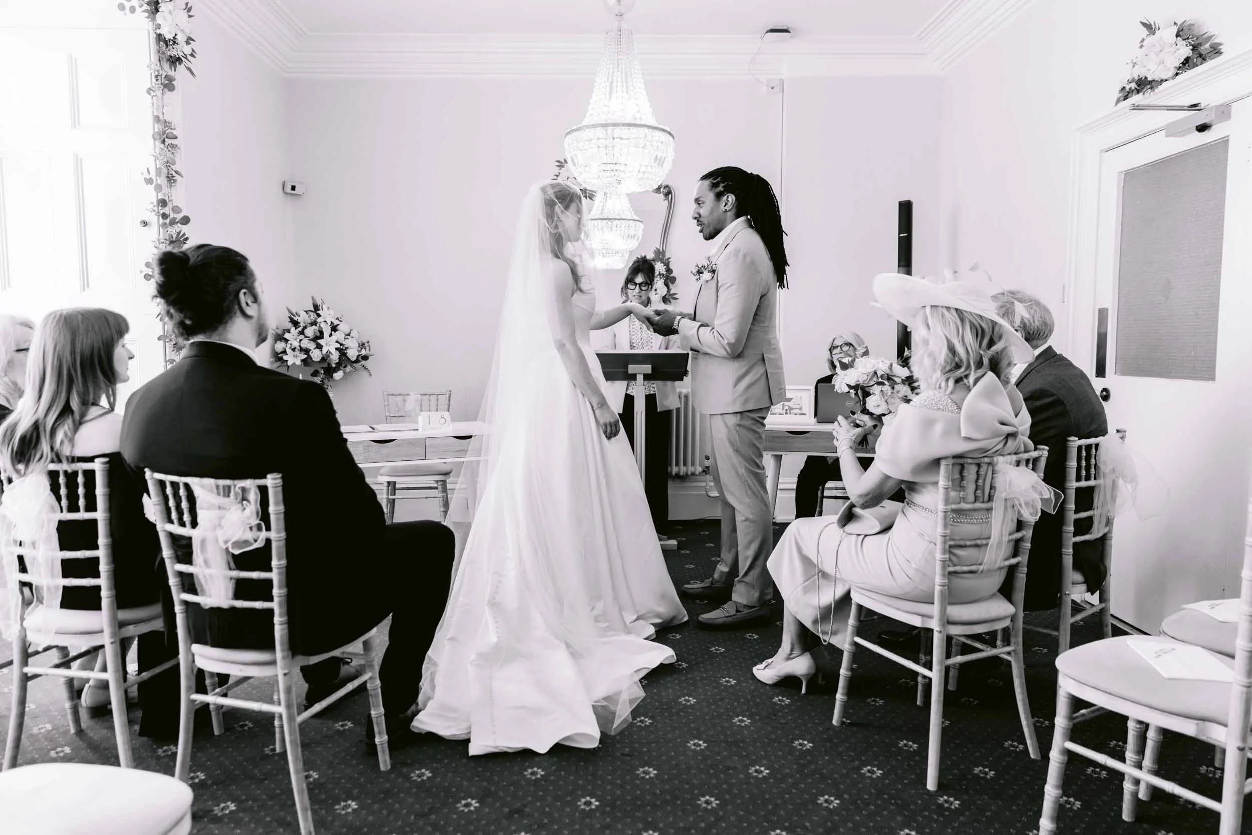A bride and groom exchanging emotional vows during an intimate civil ceremony at Guildford Register Office in Surrey.