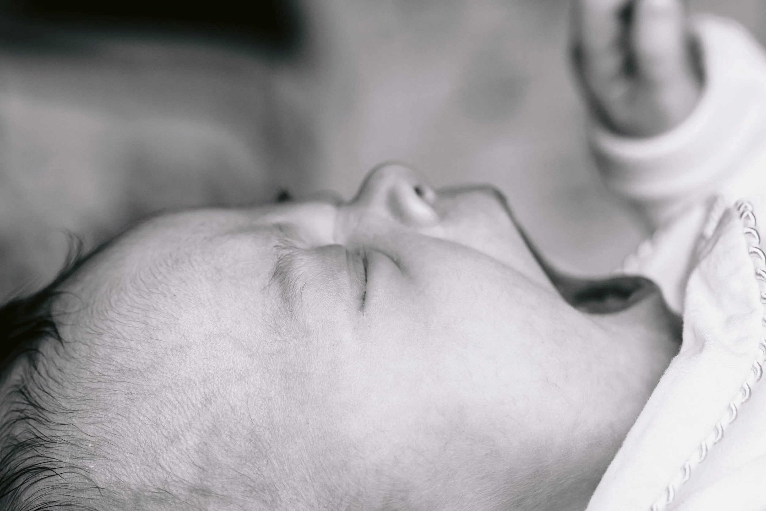 Newborn baby yawning during a newborn and pet photo session in Putney