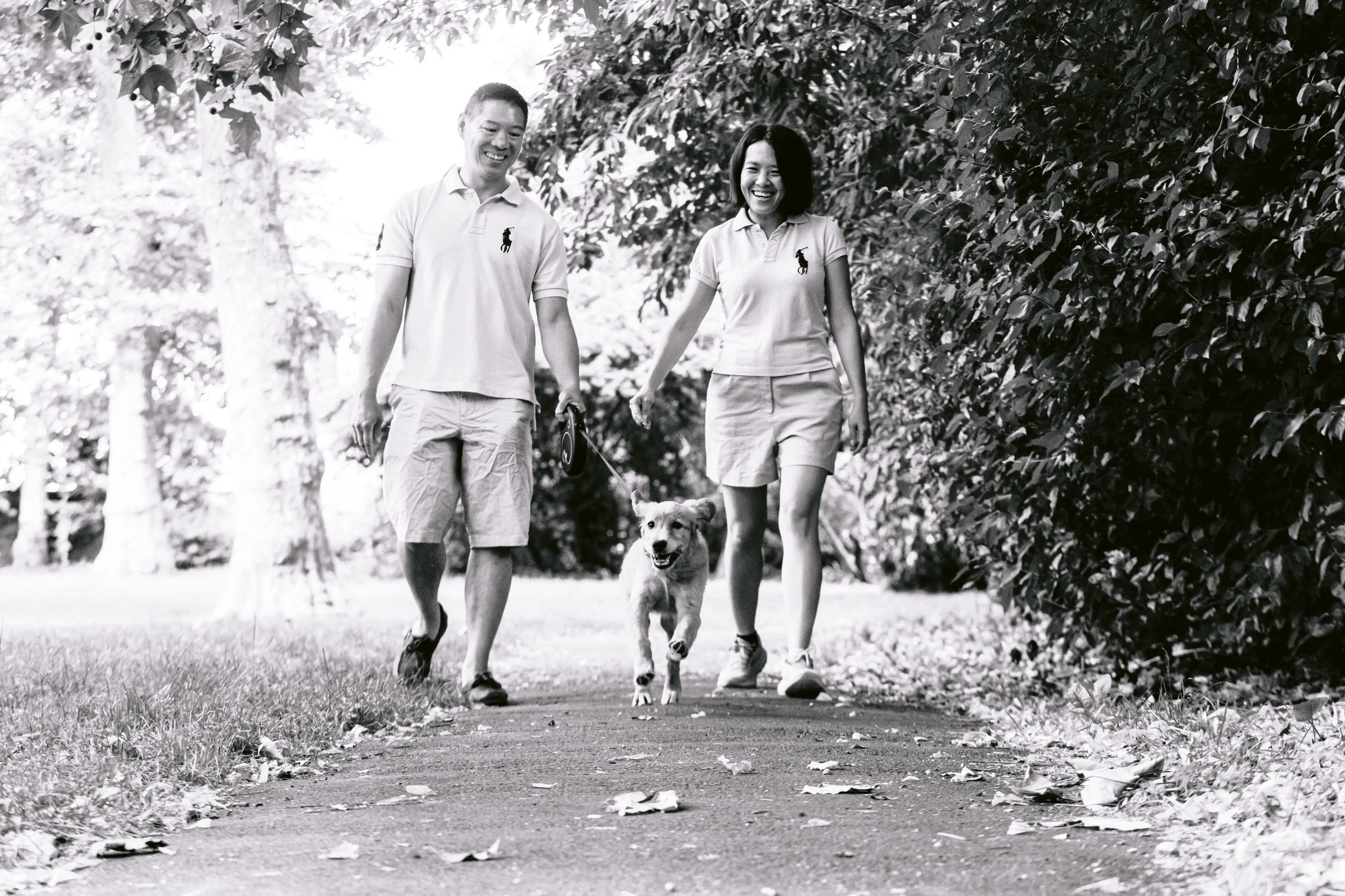 A couple walking with their dog during a puppy photo session in London