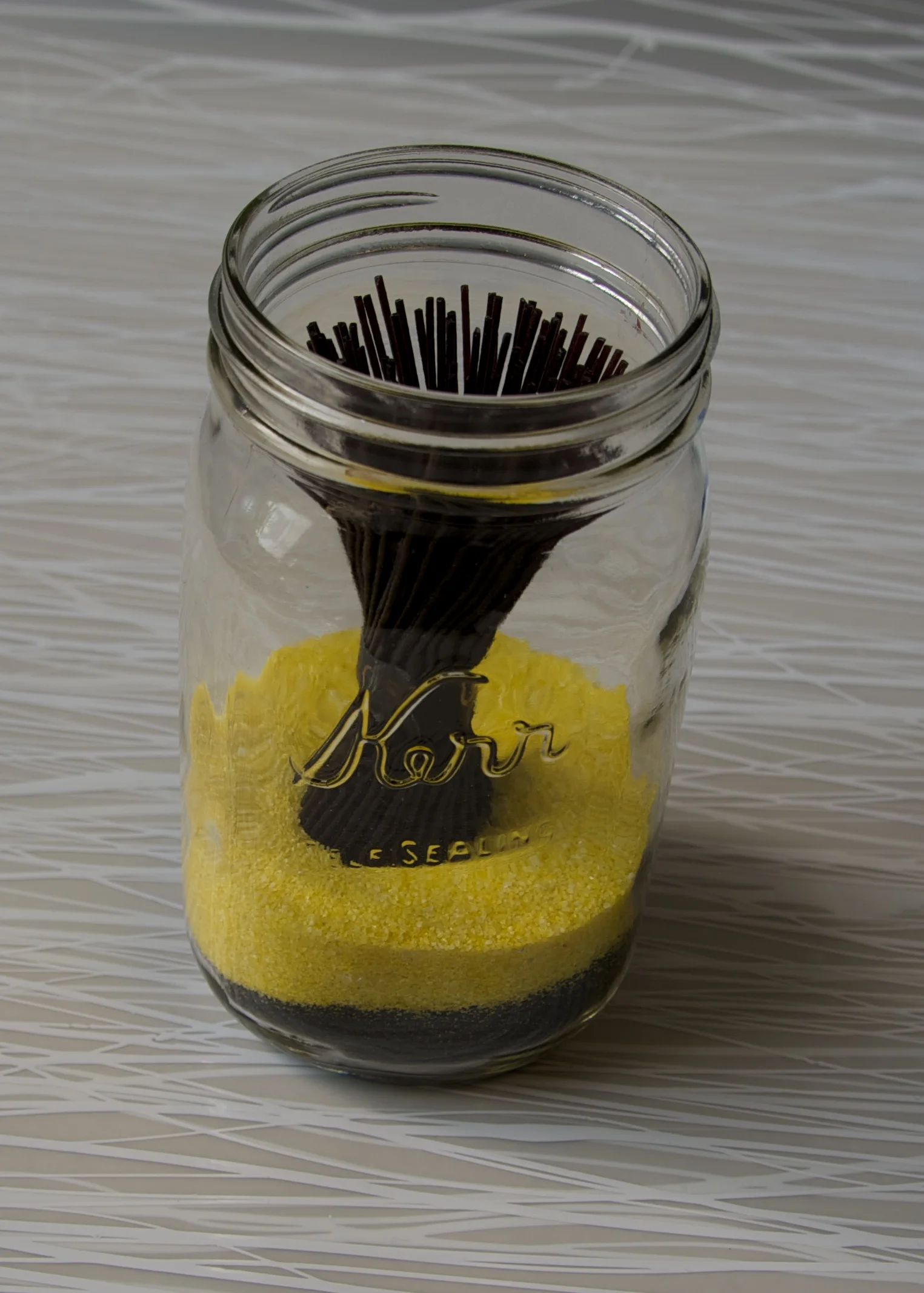 Shelf Preservation: Salt, spices, sand, vermicelli noodles, rice, coconut, seeds and artifacts. This installation investigates the tradition of canning food. It becomes the practice of the mundane becoming the spiritual and the spiritual becoming the mundane.