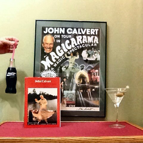 John Calvert "floated" a Coca Cola bottle with nothing but a straw and so impressed the management of Coke that they agreed to sponsor his tour. He shared that secret with me when he visited in 2009. Being the teetotaler he was, I will have my vodka martini but lift a bottle of Coca Cola to John. Cheers!
