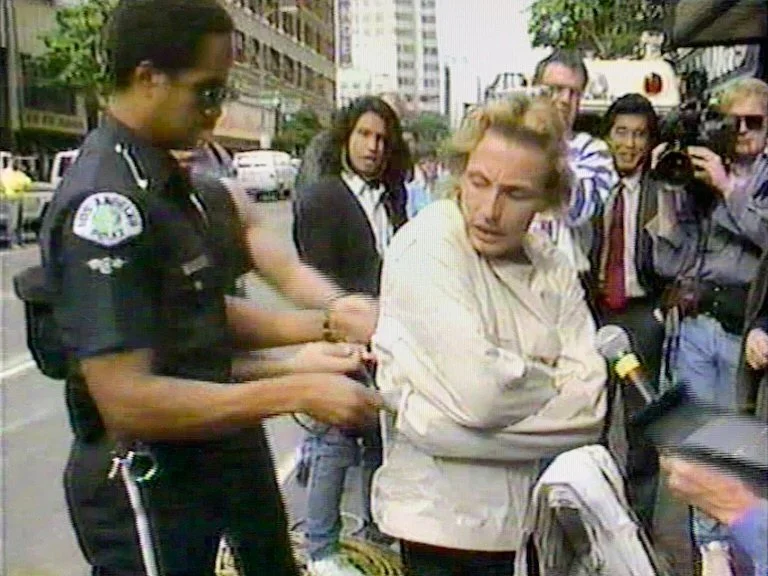 Dean and cop with straitjacket.jpg