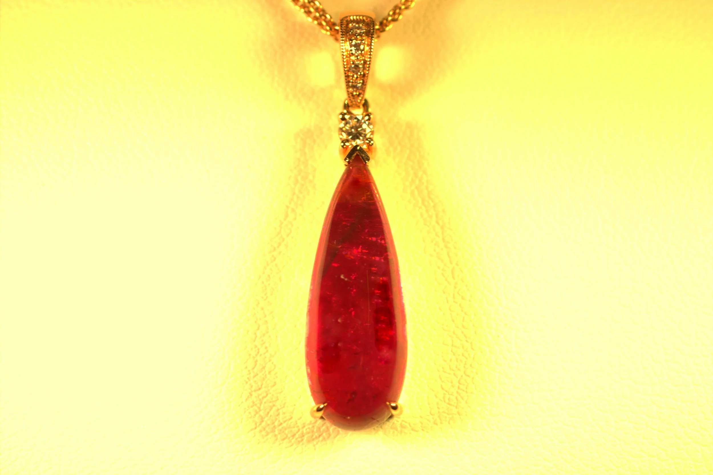 Pink tourmaline tear drop cabochon set in rose gold and white diamond bail. Great depth of color to the pink. Beautiful and classic elegance with a modern touch, and a big look. $1850