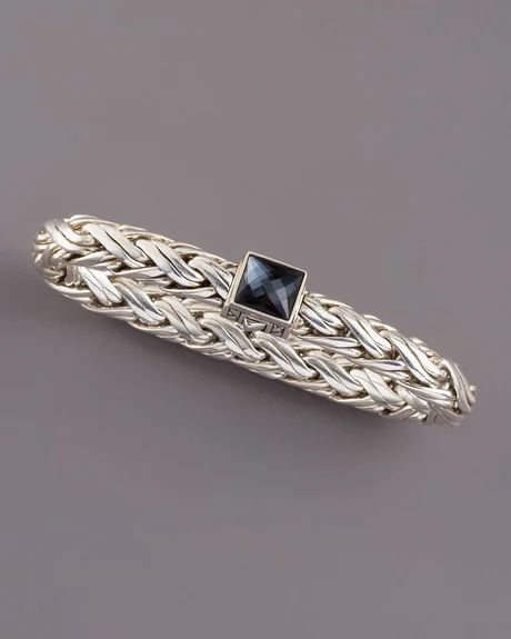 Sterling silver woven together in a rope to make a flexible smooth bracelet. The invisible clasp has a double release on either side and features a 8mm domed faceted hematite on top. The bracelet is handmade in Bali.