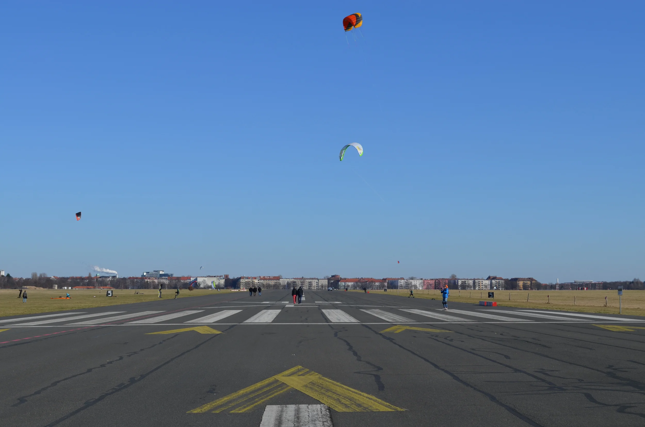 Walking along one of the runways. Kite surfing on skateboards is one of the more popular activities at the airport.