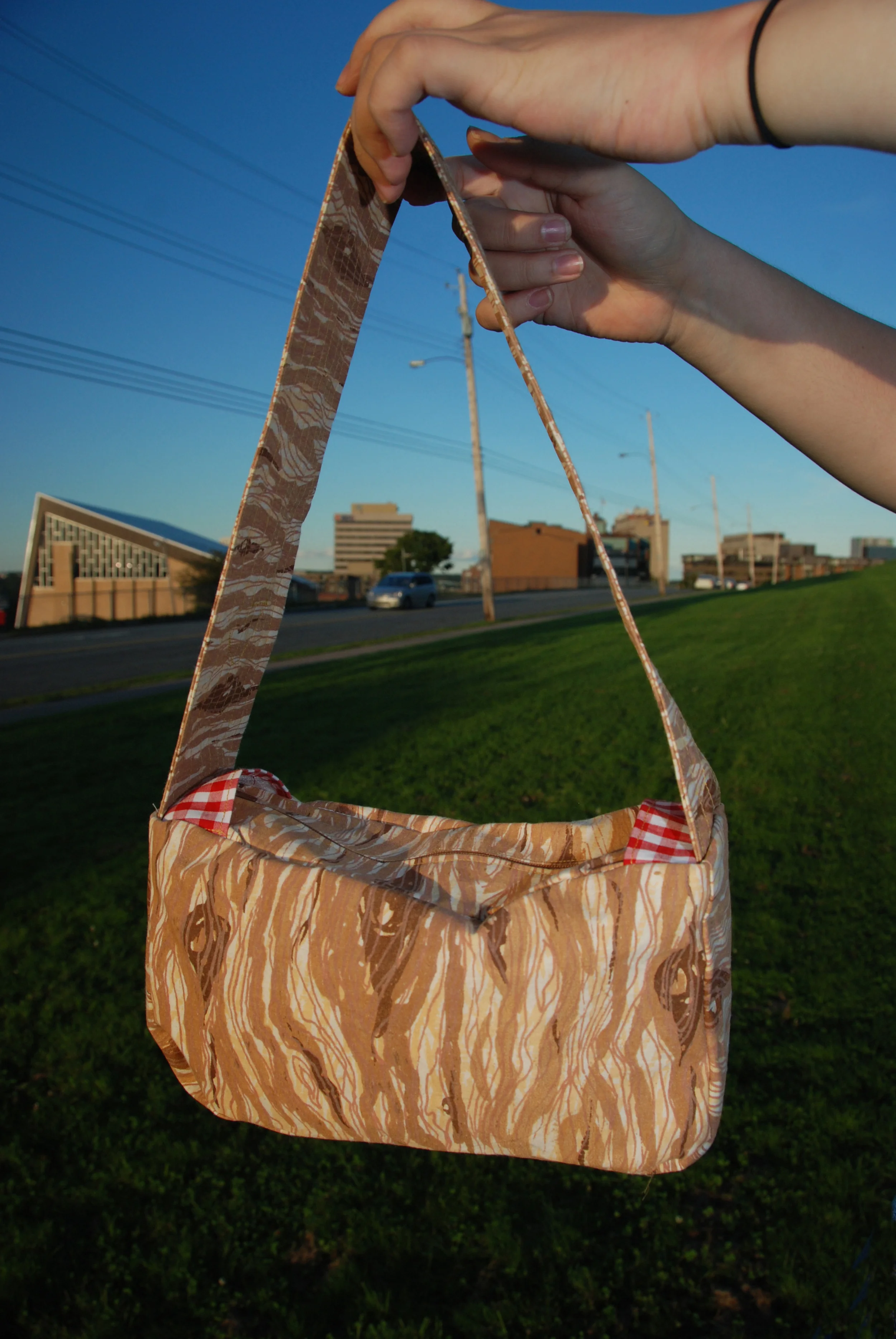 Picnic Purse, 2007 A line of purses made from a 5 colour wood grain print silkscreened on cotton. Bags featured gingham or floral liner and details, and each had a vintage Brownie badge sewn to the strap. out of print. Photo by Marlo Yarlo . 