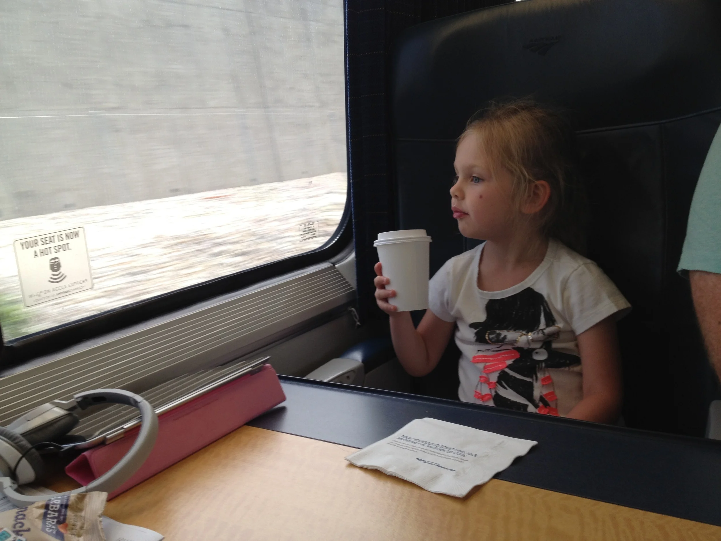 Paley on her first train ride from NYC to Boston.....coffee in hand.....nah, hot coco.