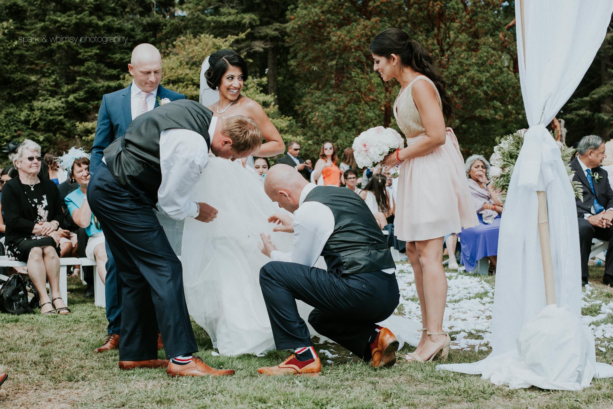 groomsmen helping bride fix dress at wedding ceremony | victoria bc wedding photographer